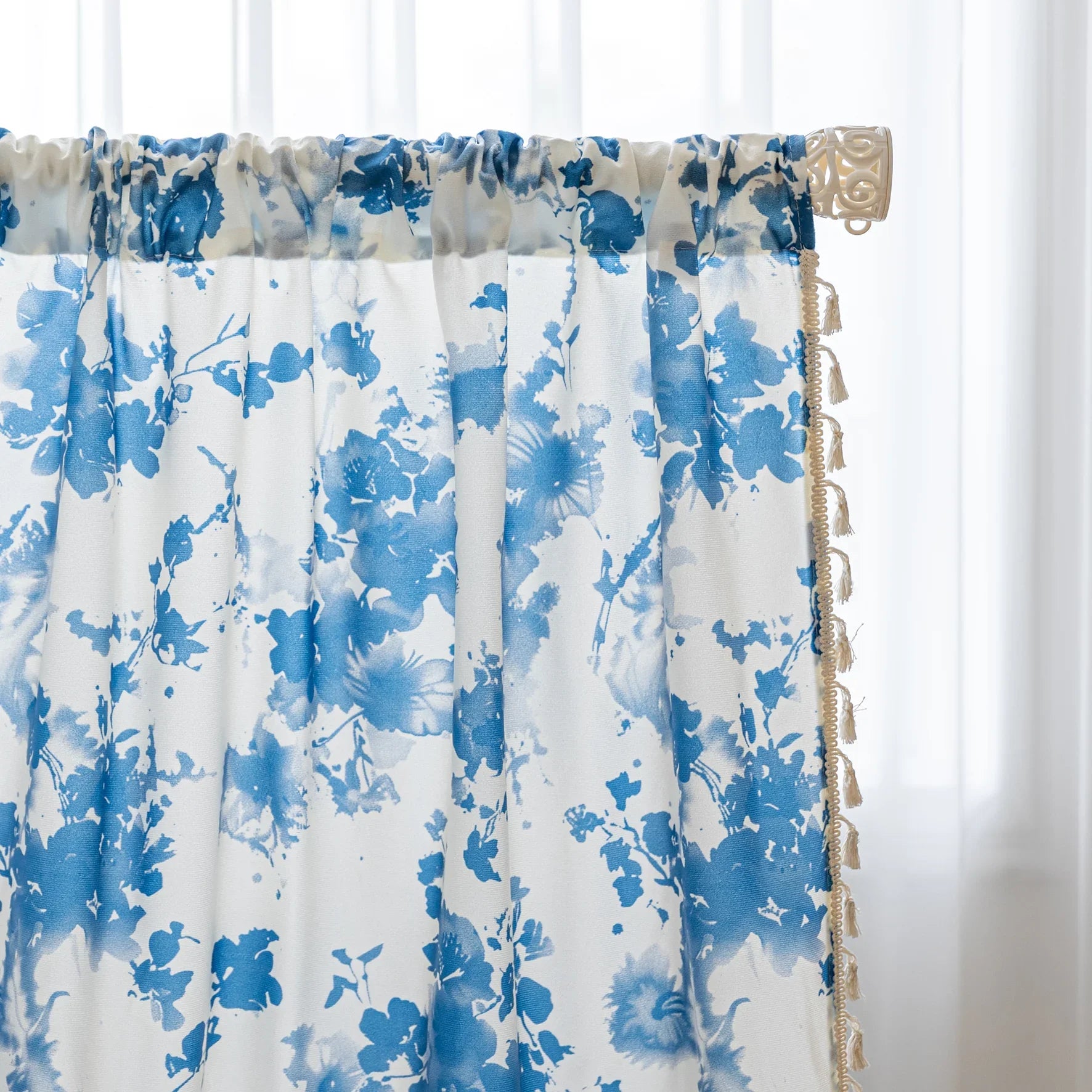 Elegant white curtain with soft watercolor-style blue floral prints, finished with delicate tassel trim — perfect for adding a fresh, airy, and romantic touch to your living room, bedroom, or cozy reading nook.