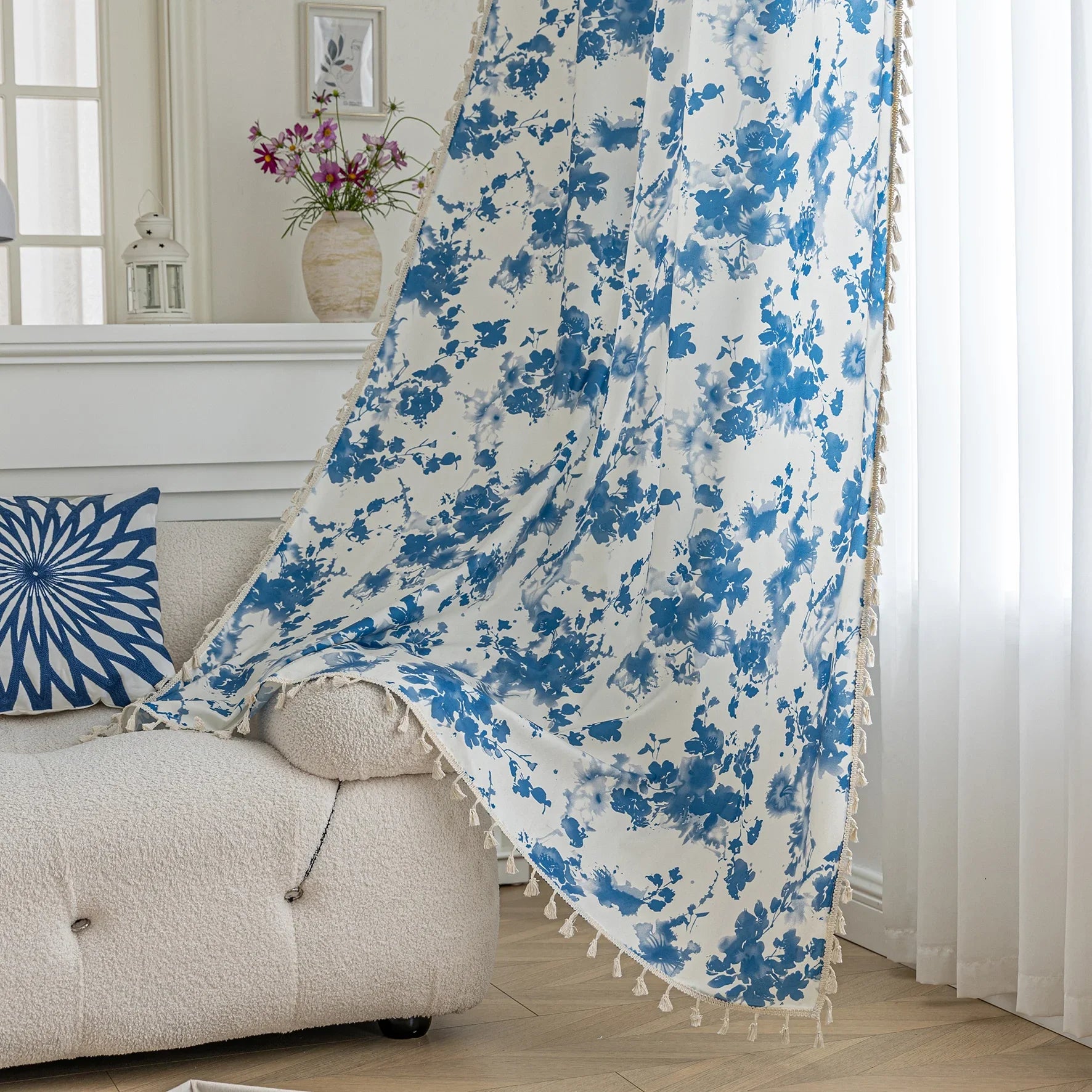 Elegant white curtain with soft watercolor-style blue floral prints, finished with delicate tassel trim — perfect for adding a fresh, airy, and romantic touch to your living room, bedroom, or cozy reading nook.