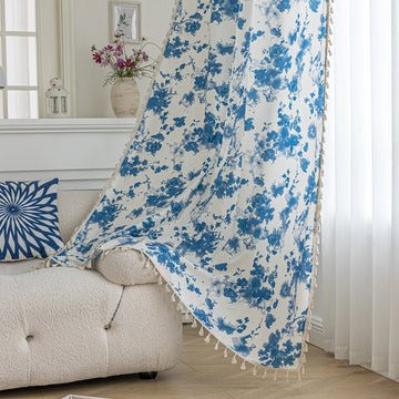 Elegant white curtain with soft watercolor-style blue floral prints, finished with delicate tassel trim — perfect for adding a fresh, airy, and romantic touch to your living room, bedroom, or cozy reading nook.