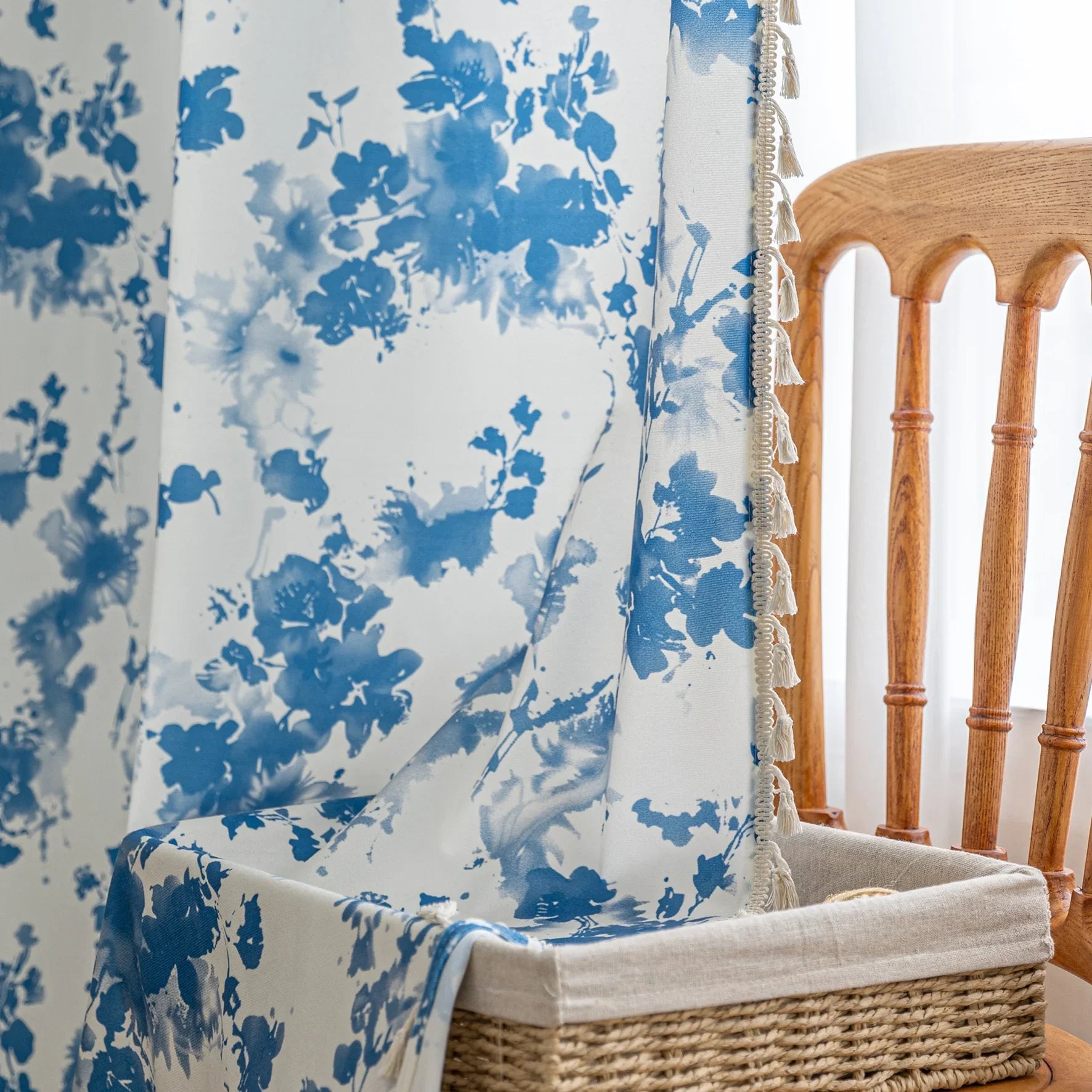 Elegant white curtain with soft watercolor-style blue floral prints, finished with delicate tassel trim — perfect for adding a fresh, airy, and romantic touch to your living room, bedroom, or cozy reading nook.