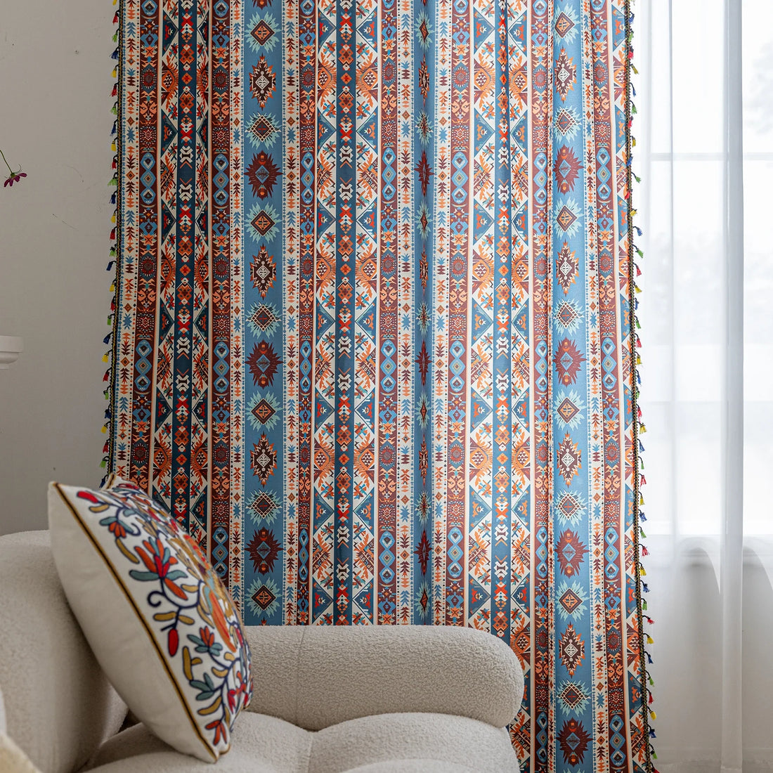 Vibrant bohemian curtain with a striking tribal geometric pattern in earthy rust, deep blue, and cream tones, accented with colorful tassel trim — perfect for adding warmth, character, and a Southwestern-inspired charm to any room.