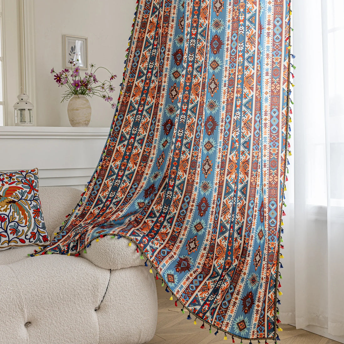 Vibrant bohemian curtain with a striking tribal geometric pattern in earthy rust, deep blue, and cream tones, accented with colorful tassel trim — perfect for adding warmth, character, and a Southwestern-inspired charm to any room.