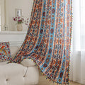 Vibrant bohemian curtain with a striking tribal geometric pattern in earthy rust, deep blue, and cream tones, accented with colorful tassel trim — perfect for adding warmth, character, and a Southwestern-inspired charm to any room.
