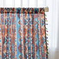 Vibrant bohemian curtain with a striking tribal geometric pattern in earthy rust, deep blue, and cream tones, accented with colorful tassel trim — perfect for adding warmth, character, and a Southwestern-inspired charm to any room.