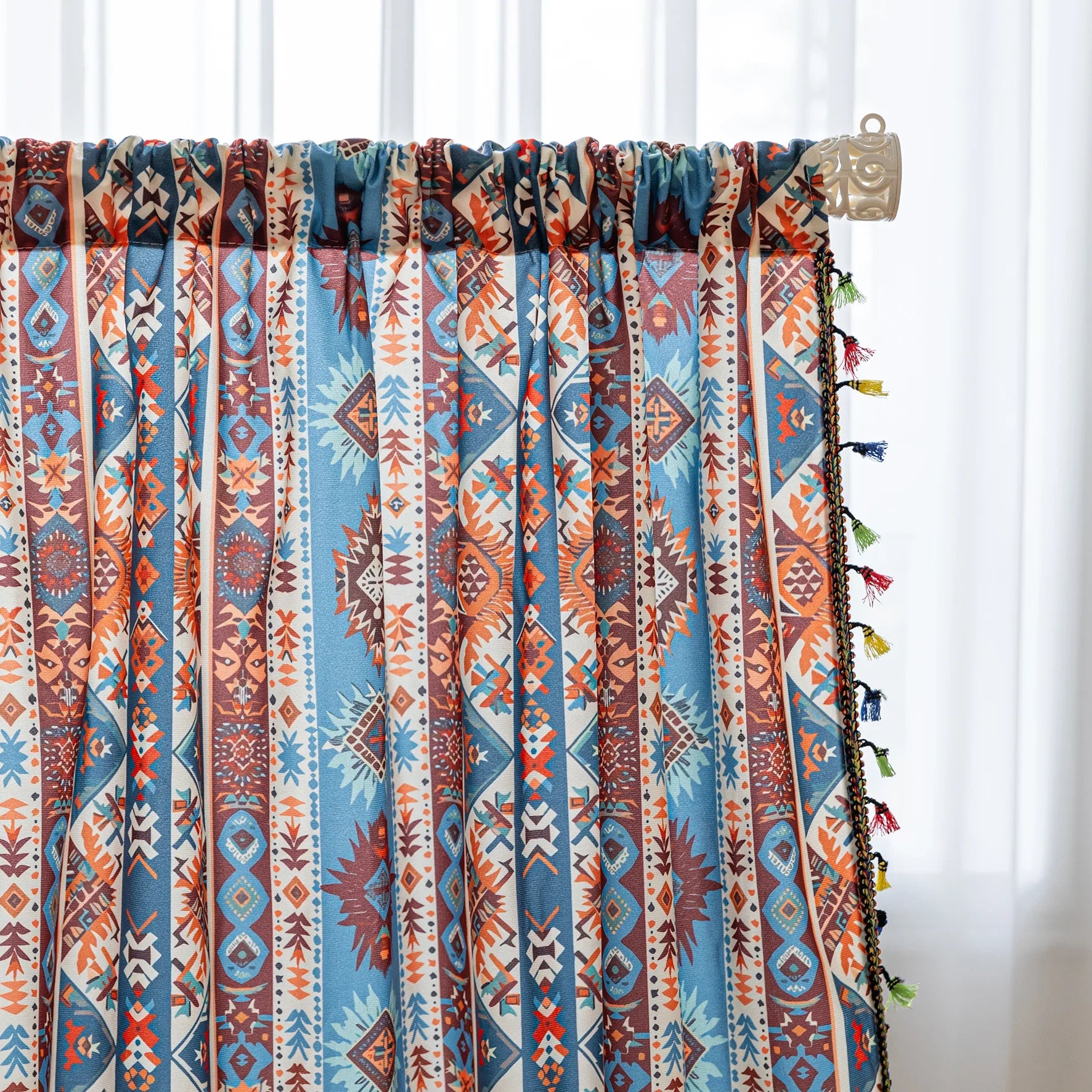 Vibrant bohemian curtain with a striking tribal geometric pattern in earthy rust, deep blue, and cream tones, accented with colorful tassel trim — perfect for adding warmth, character, and a Southwestern-inspired charm to any room.