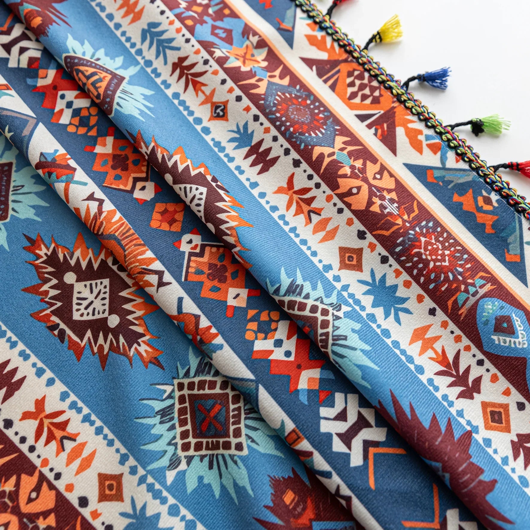 Vibrant bohemian curtain with a striking tribal geometric pattern in earthy rust, deep blue, and cream tones, accented with colorful tassel trim — perfect for adding warmth, character, and a Southwestern-inspired charm to any room.
