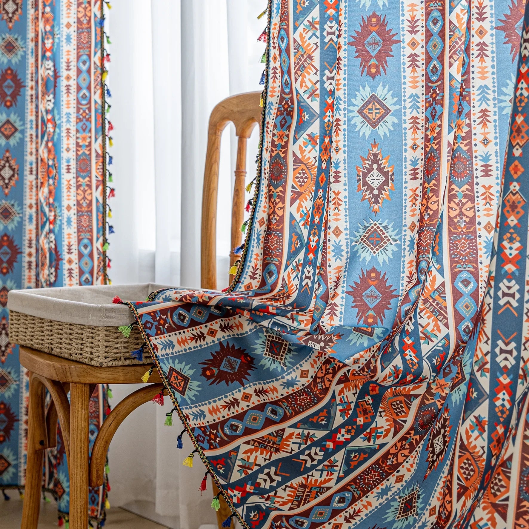 Vibrant bohemian curtain with a striking tribal geometric pattern in earthy rust, deep blue, and cream tones, accented with colorful tassel trim — perfect for adding warmth, character, and a Southwestern-inspired charm to any room.