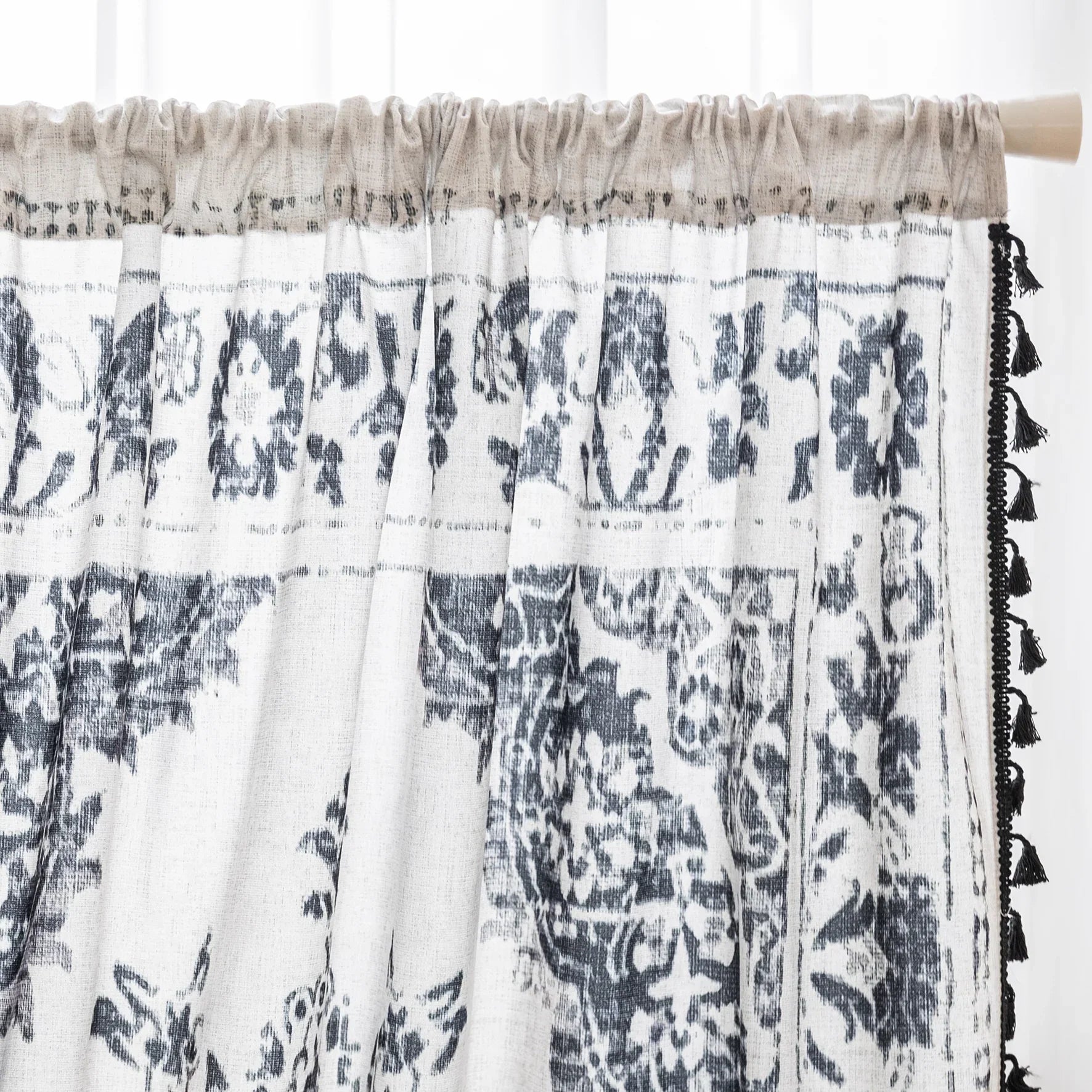 Elegant bohemian curtain in soft beige with intricate black floral and medallion motifs, finished with delicate black tassel trim — perfect for adding vintage charm and artistic flair to living rooms, bedrooms, or creative spaces.