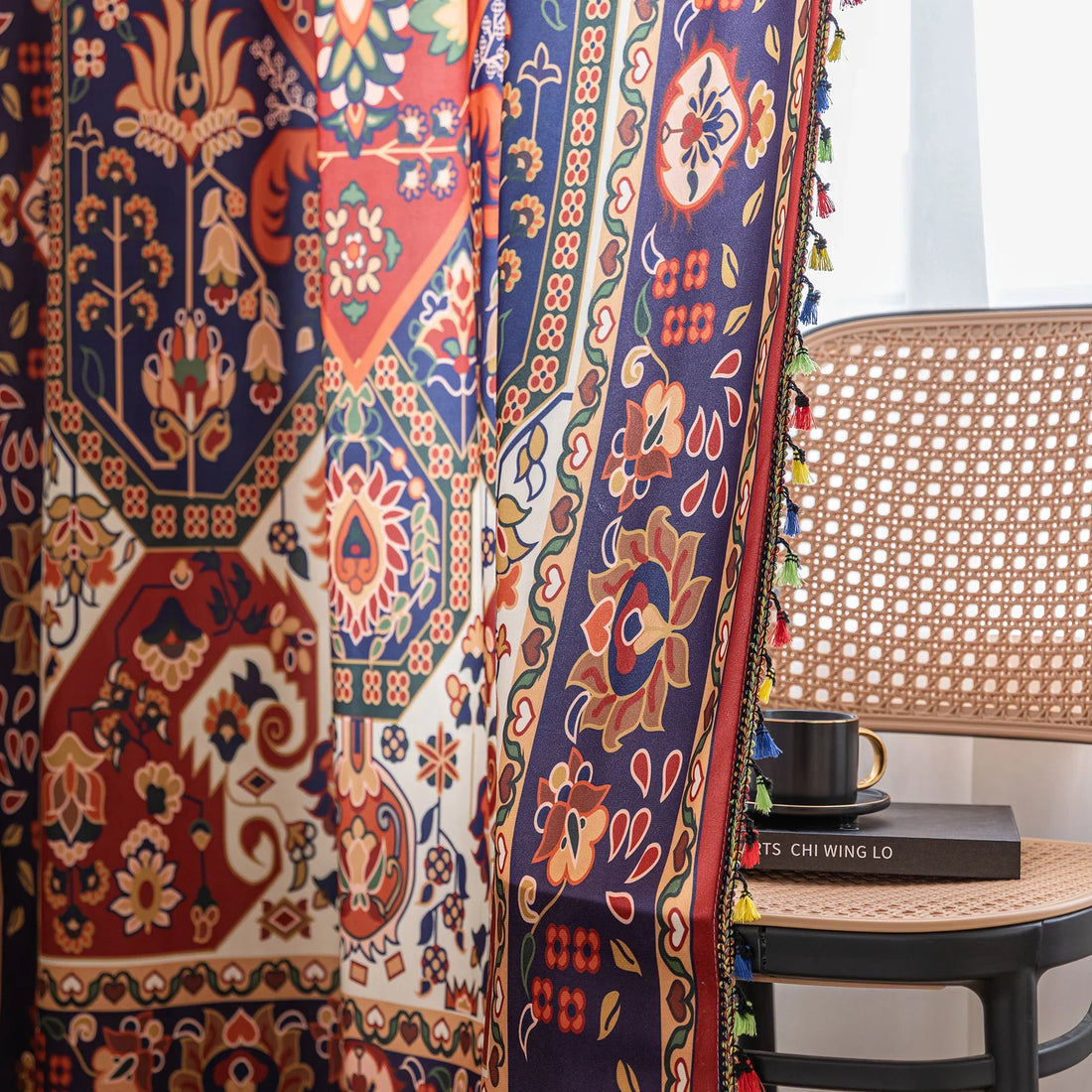 Eye-catching curtain showcasing a rich blend of red, navy, and cream tones with intricate floral and geometric motifs, finished with colorful tassel edging — ideal for creating a warm, artistic, and culturally inspired home ambiance.