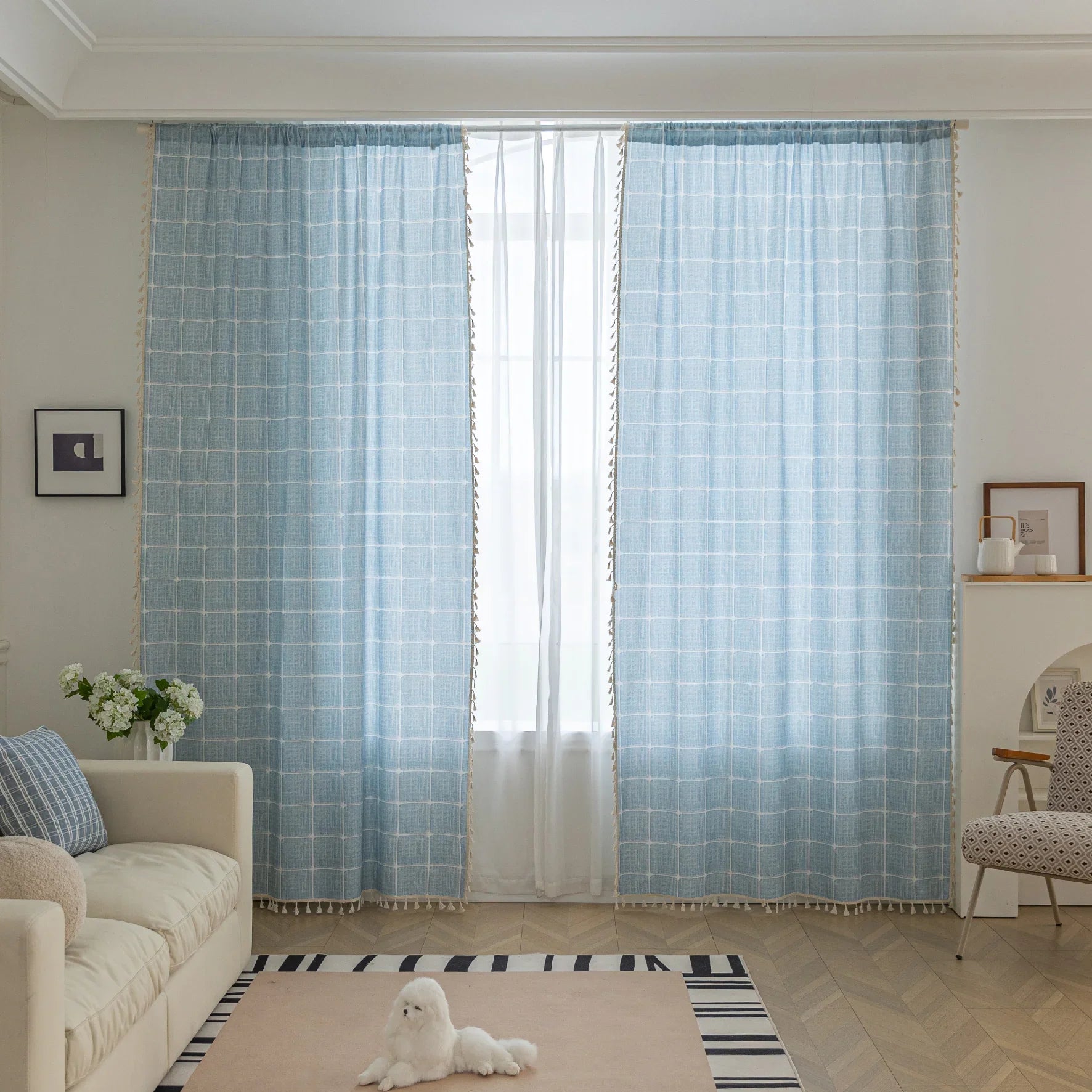 Sky blue curtain with a delicate white grid pattern and tassel trim — a stylish and airy window treatment that brightens your space while adding a modern, cozy touch.