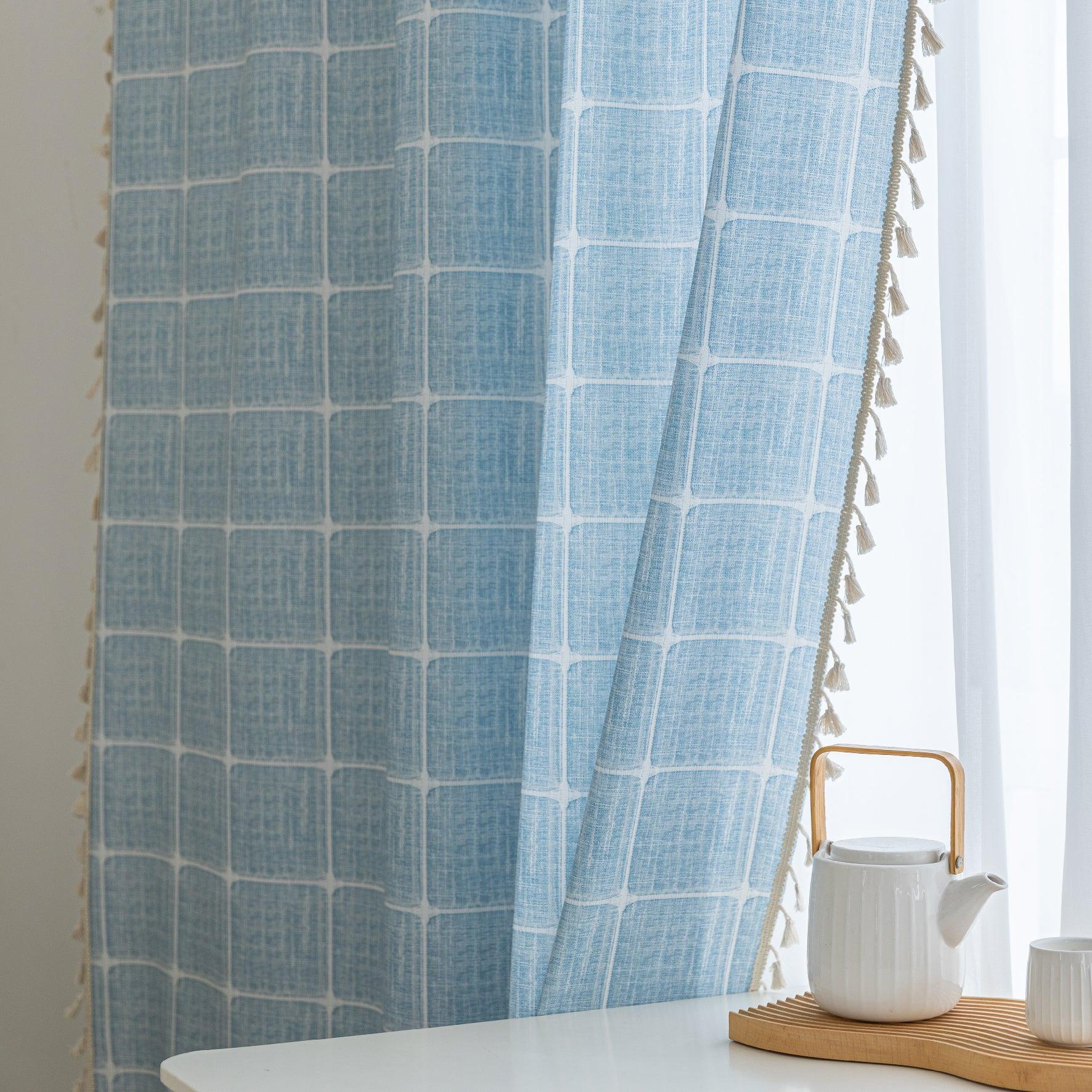 Sky blue curtain with a delicate white grid pattern and tassel trim — a stylish and airy window treatment that brightens your space while adding a modern, cozy touch.