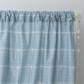 Sky blue curtain with a delicate white grid pattern and tassel trim — a stylish and airy window treatment that brightens your space while adding a modern, cozy touch.