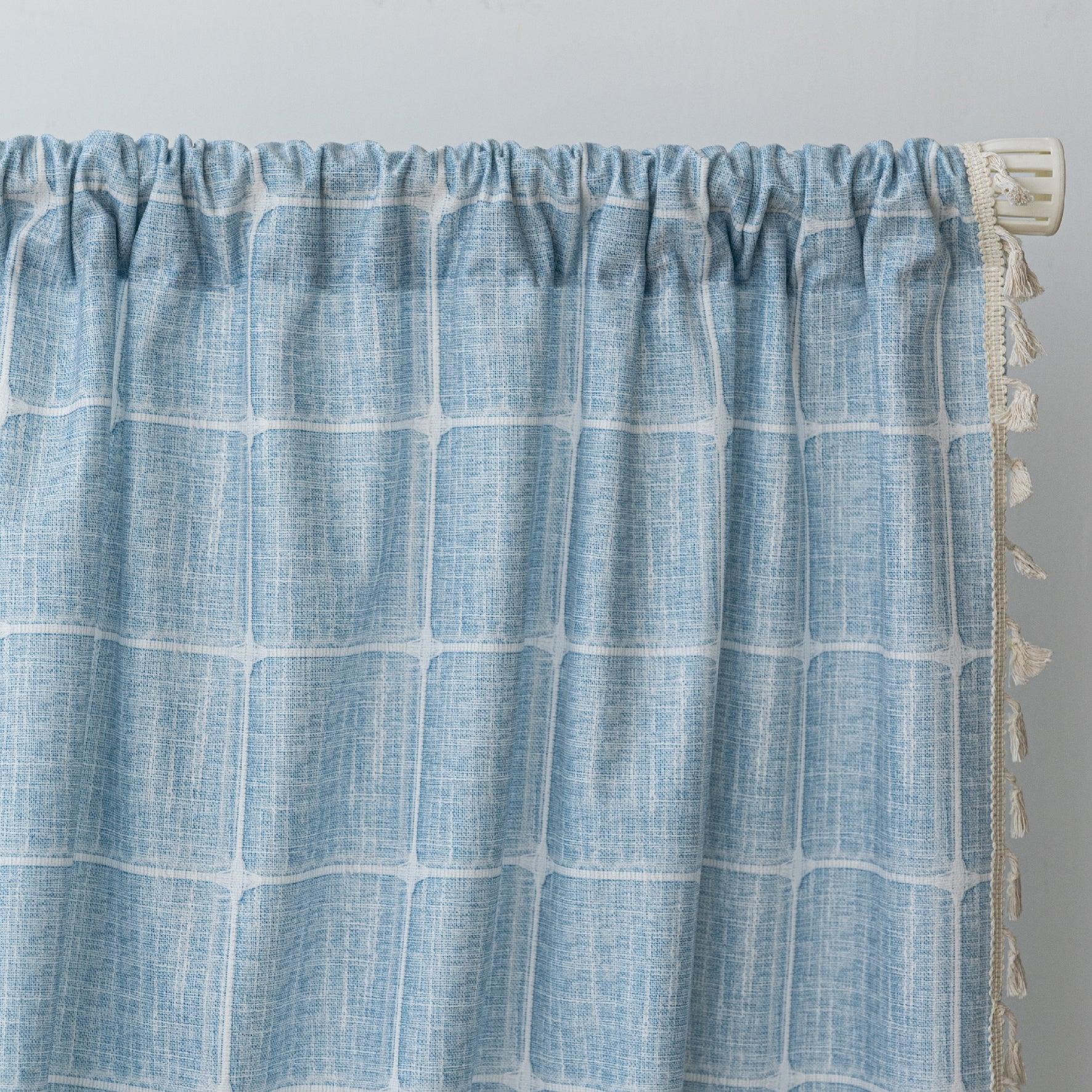 Sky blue curtain with a delicate white grid pattern and tassel trim — a stylish and airy window treatment that brightens your space while adding a modern, cozy touch.