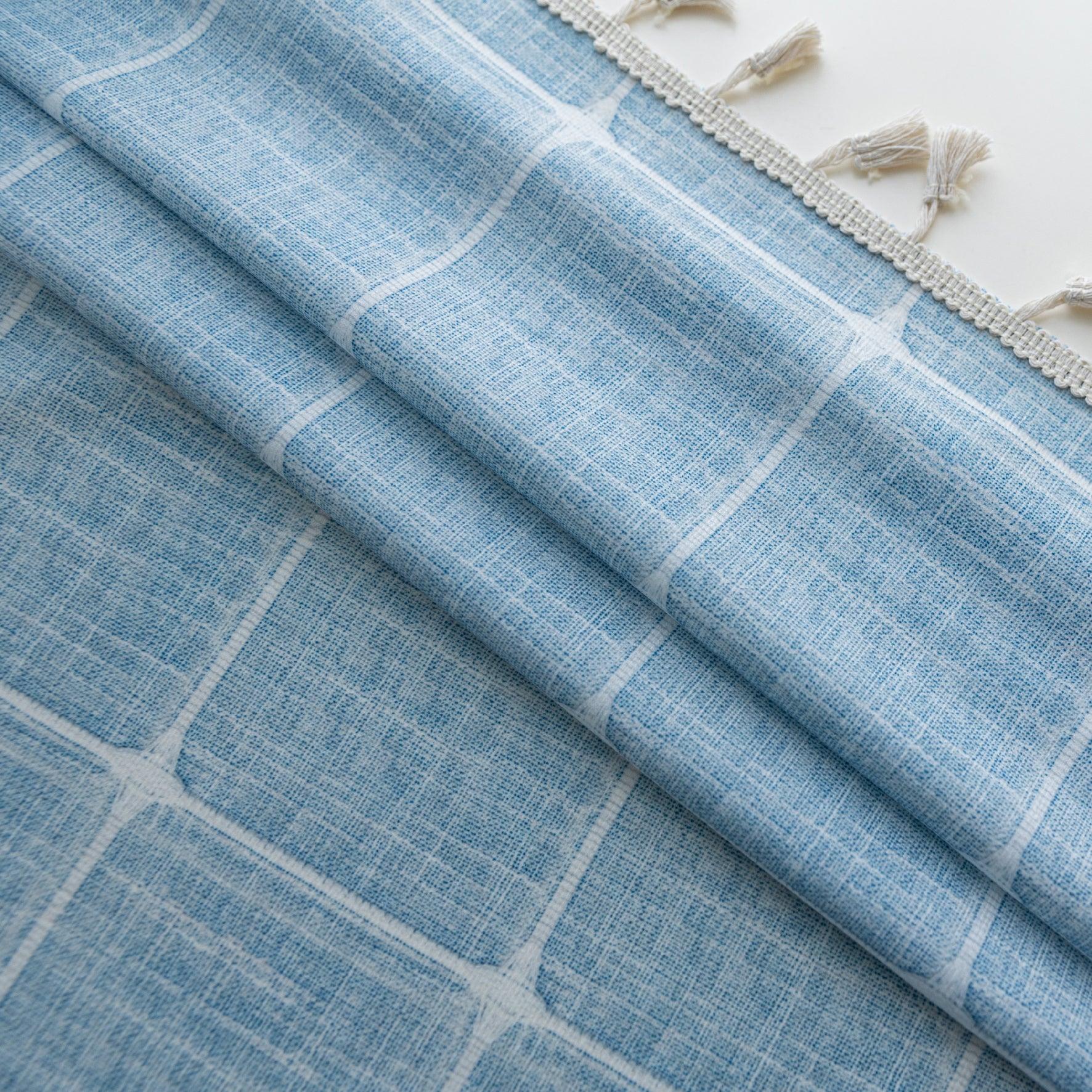 Sky blue curtain with a delicate white grid pattern and tassel trim — a stylish and airy window treatment that brightens your space while adding a modern, cozy touch.