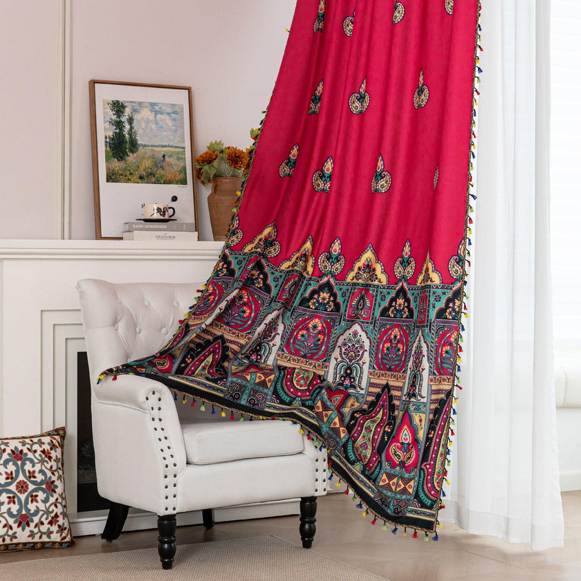 Vibrant Red Bohemian Curtains ¨C Infuse your home with bold color and artistic flair using these stunning red curtains adorned with intricate multicolor ethnic patterns. The rich crimson backdrop is complemented by an elaborate border design in green, gold, and black, with small paisley-style motifs scattered throughout. Crafted from lightweight fabric, they softly filter sunlight while adding a warm, inviting atmosphere to any room. Perfect for living rooms, bedrooms, or creative spaces, these tassel-trimm