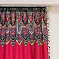Vibrant Red Bohemian Curtains – Infuse your home with bold color and artistic flair using these stunning red curtains adorned with intricate multicolor ethnic patterns. The rich crimson backdrop is complemented by an elaborate border design in green, gold, and black, with small paisley-style motifs scattered throughout. Crafted from lightweight fabric, they softly filter sunlight while adding a warm, inviting atmosphere to any room. Perfect for living rooms, bedrooms, or creative spaces, these tassel-trimme