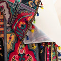Vibrant Red Bohemian Curtains – Infuse your home with bold color and artistic flair using these stunning red curtains adorned with intricate multicolor ethnic patterns. The rich crimson backdrop is complemented by an elaborate border design in green, gold, and black, with small paisley-style motifs scattered throughout. Crafted from lightweight fabric, they softly filter sunlight while adding a warm, inviting atmosphere to any room. Perfect for living rooms, bedrooms, or creative spaces, these tassel-trimme