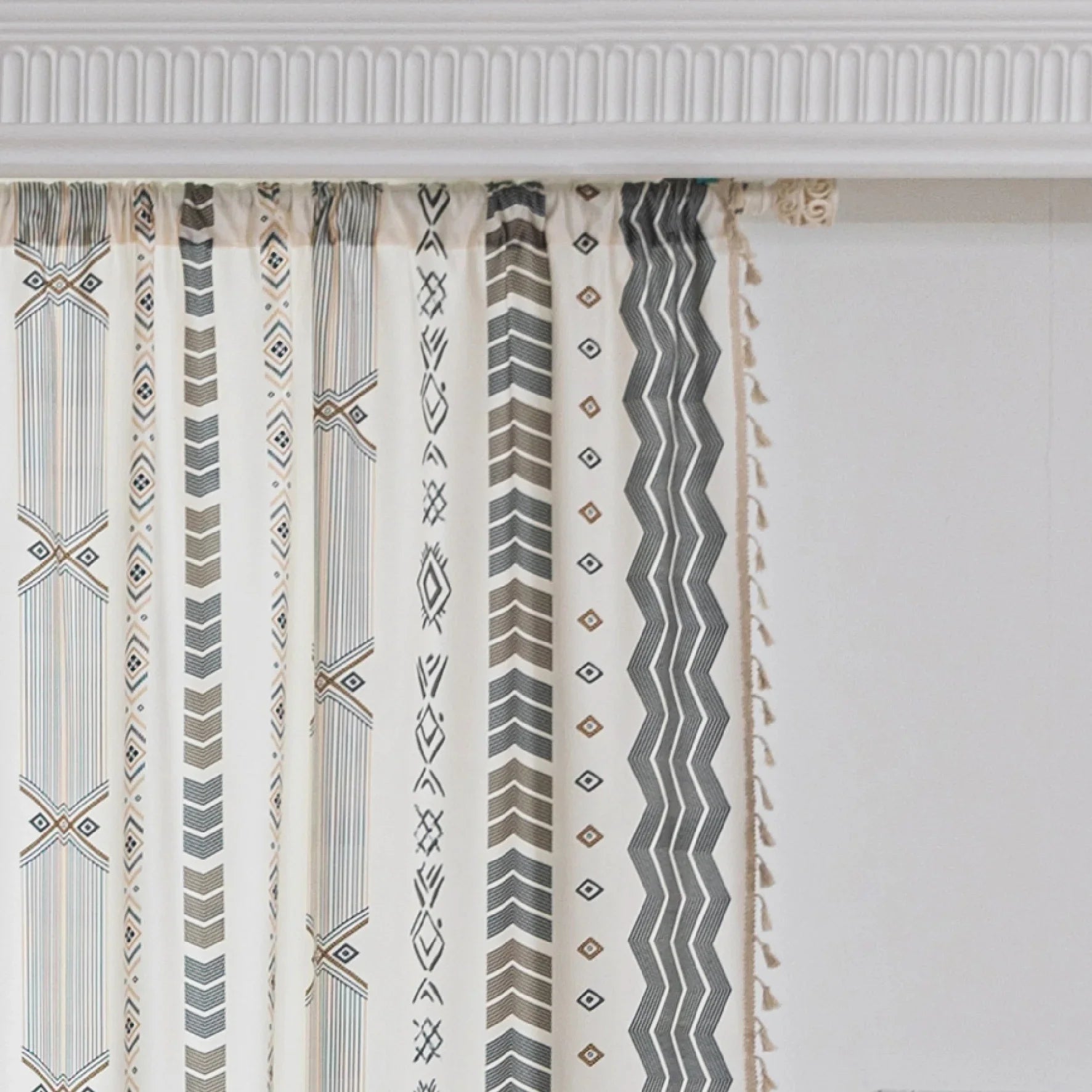 Boho Geometric Patterned Curtains – Elevate your home décor with these elegant cream curtains featuring intricate tribal-inspired geometric designs in earthy gray, beige, and gold tones. Crafted from soft, breathable fabric, they allow gentle natural light to filter through while providing a cozy, inviting atmosphere. The stylish tassel trim adds a charming bohemian touch, making them perfect for living rooms, bedrooms, or creative spaces seeking a modern yet warm aesthetic.
