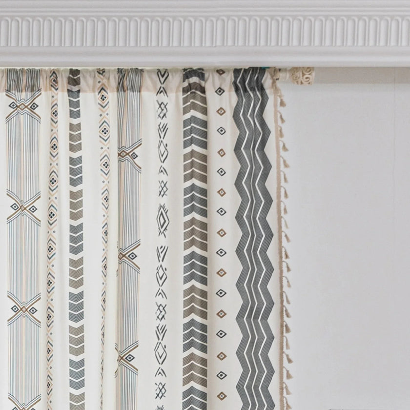 Boho Geometric Patterned Curtains ¨C Elevate your home d¨¦cor with these elegant cream curtains featuring intricate tribal-inspired geometric designs in earthy gray, beige, and gold tones. Crafted from soft, breathable fabric, they allow gentle natural light to filter through while providing a cozy, inviting atmosphere. The stylish tassel trim adds a charming bohemian touch, making them perfect for living rooms, bedrooms, or creative spaces seeking a modern yet warm aesthetic.
