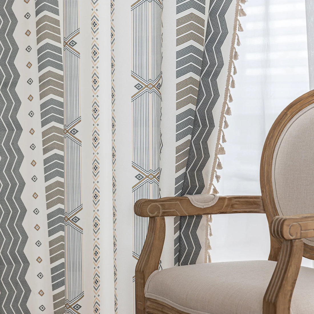 Boho Geometric Patterned Curtains – Elevate your home décor with these elegant cream curtains featuring intricate tribal-inspired geometric designs in earthy gray, beige, and gold tones. Crafted from soft, breathable fabric, they allow gentle natural light to filter through while providing a cozy, inviting atmosphere. The stylish tassel trim adds a charming bohemian touch, making them perfect for living rooms, bedrooms, or creative spaces seeking a modern yet warm aesthetic.

