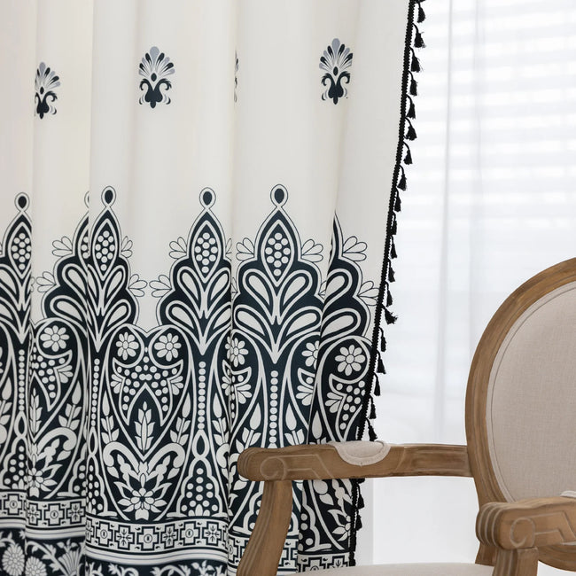 Elegant Black and White Bohemian Curtains ¨C Add timeless charm to your home with these white curtains adorned with intricate black floral and paisley patterns. The bold border design at the base transitions into delicate motifs toward the top, creating a balanced, eye-catching look. Made from soft, lightweight fabric, they allow natural light to filter through while maintaining privacy. Perfect for living rooms, bedrooms, or creative spaces, these tassel-trimmed curtains bring a sophisticated boho vibe to 