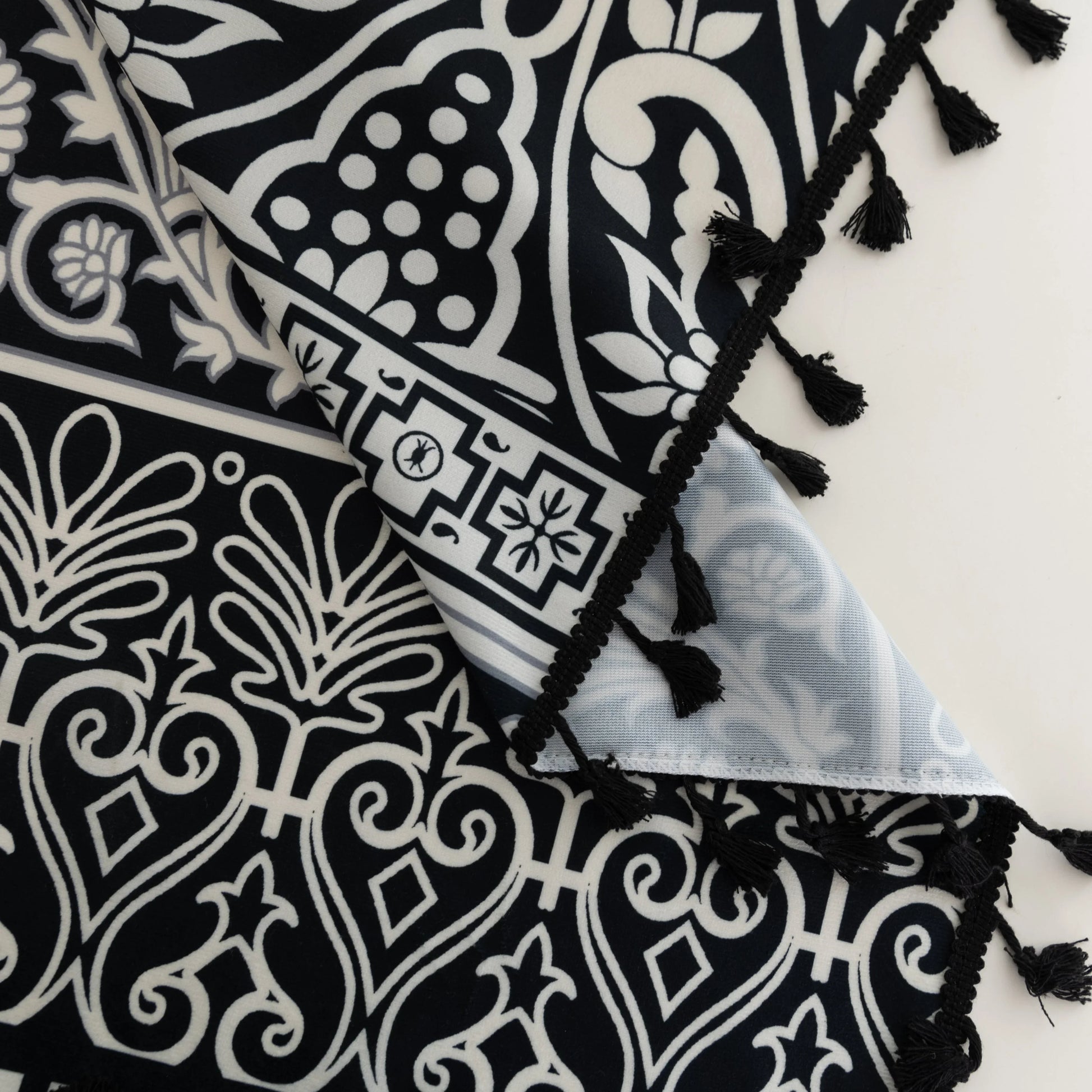 Elegant Black and White Bohemian Curtains – Add timeless charm to your home with these white curtains adorned with intricate black floral and paisley patterns. The bold border design at the base transitions into delicate motifs toward the top, creating a balanced, eye-catching look. Made from soft, lightweight fabric, they allow natural light to filter through while maintaining privacy. Perfect for living rooms, bedrooms, or creative spaces, these tassel-trimmed curtains bring a sophisticated boho vibe to a
