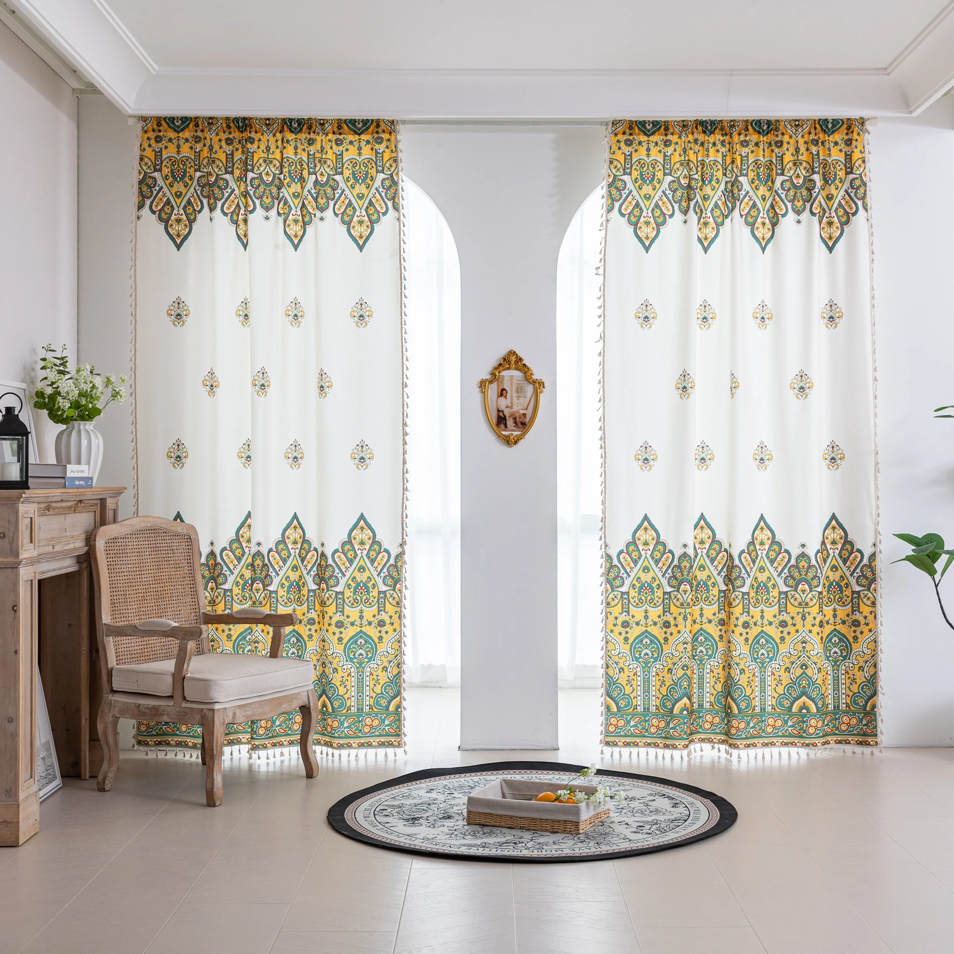 Bohemian Paisley Print Curtains – Brighten your space with these vibrant white curtains featuring an intricate paisley design in rich yellow, green, and red tones. The elegant pattern starts at the base and gracefully fades upward, adding a unique artistic touch to your home décor. Made from lightweight, breathable fabric, they allow soft natural light to flow in while enhancing any living room, bedroom, or creative space with a warm, eclectic charm. Tassel trim along the edges completes the boho-inspired l