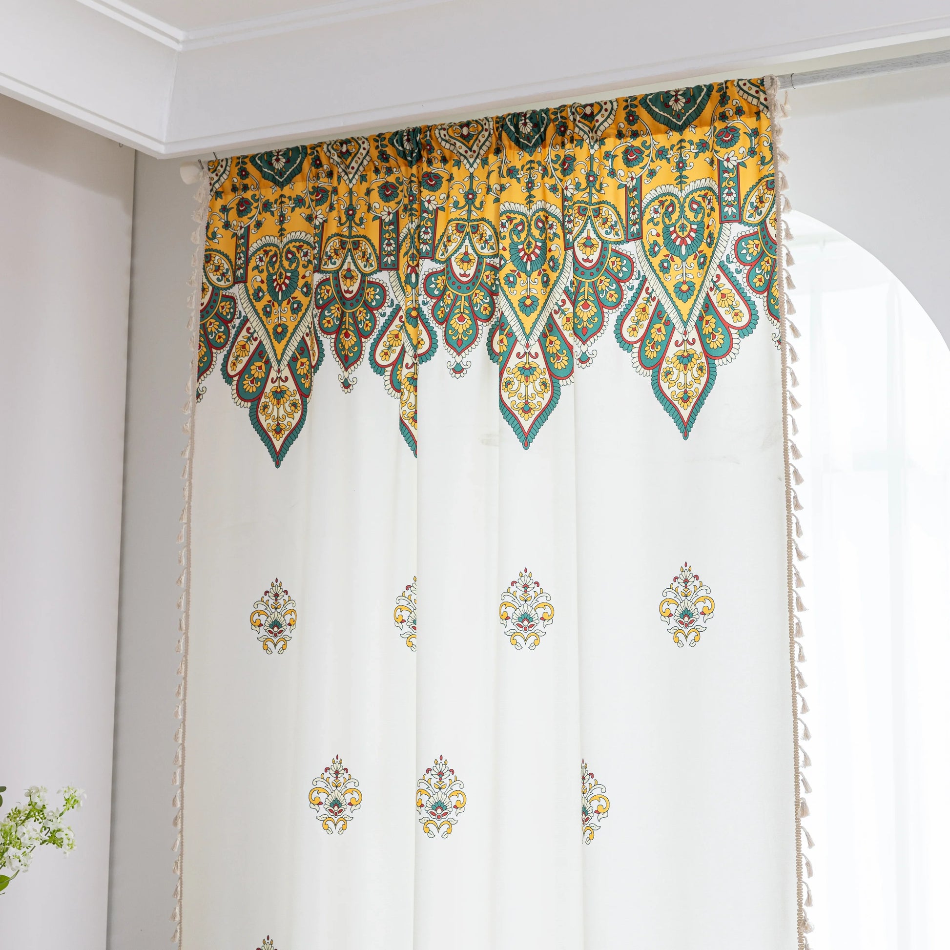Bohemian Paisley Print Curtains – Brighten your space with these vibrant white curtains featuring an intricate paisley design in rich yellow, green, and red tones. The elegant pattern starts at the base and gracefully fades upward, adding a unique artistic touch to your home décor. Made from lightweight, breathable fabric, they allow soft natural light to flow in while enhancing any living room, bedroom, or creative space with a warm, eclectic charm. Tassel trim along the edges completes the boho-inspired l