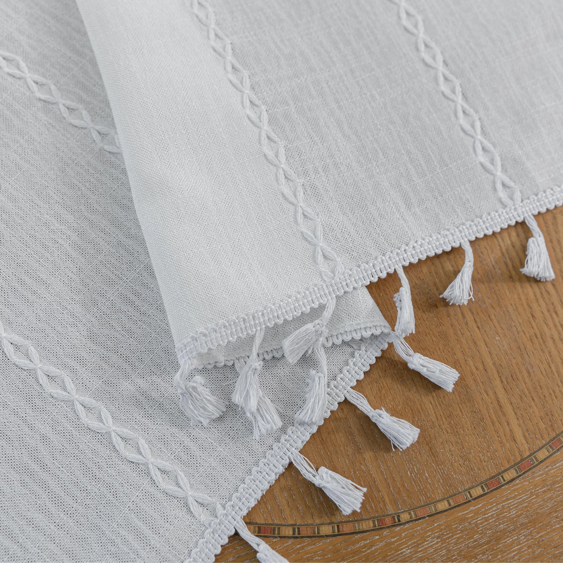 Elegant White Tassel Curtains – Bring timeless charm and brightness to your home with these beautiful white curtains, featuring subtle vertical embroidery and delicate tassel trim. Crafted from soft, airy fabric, they allow natural light to flow in while preserving your privacy. Perfect for living rooms, bedrooms, or dining spaces, their clean, versatile design complements modern, minimalist, coastal, or bohemian décor styles. Durable, easy to maintain, and effortlessly stylish, these curtains add a fresh a