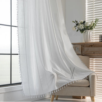 Elegant White Tassel Curtains – Bring timeless charm and brightness to your home with these beautiful white curtains, featuring subtle vertical embroidery and delicate tassel trim. Crafted from soft, airy fabric, they allow natural light to flow in while preserving your privacy. Perfect for living rooms, bedrooms, or dining spaces, their clean, versatile design complements modern, minimalist, coastal, or bohemian décor styles. Durable, easy to maintain, and effortlessly stylish, these curtains add a fresh a