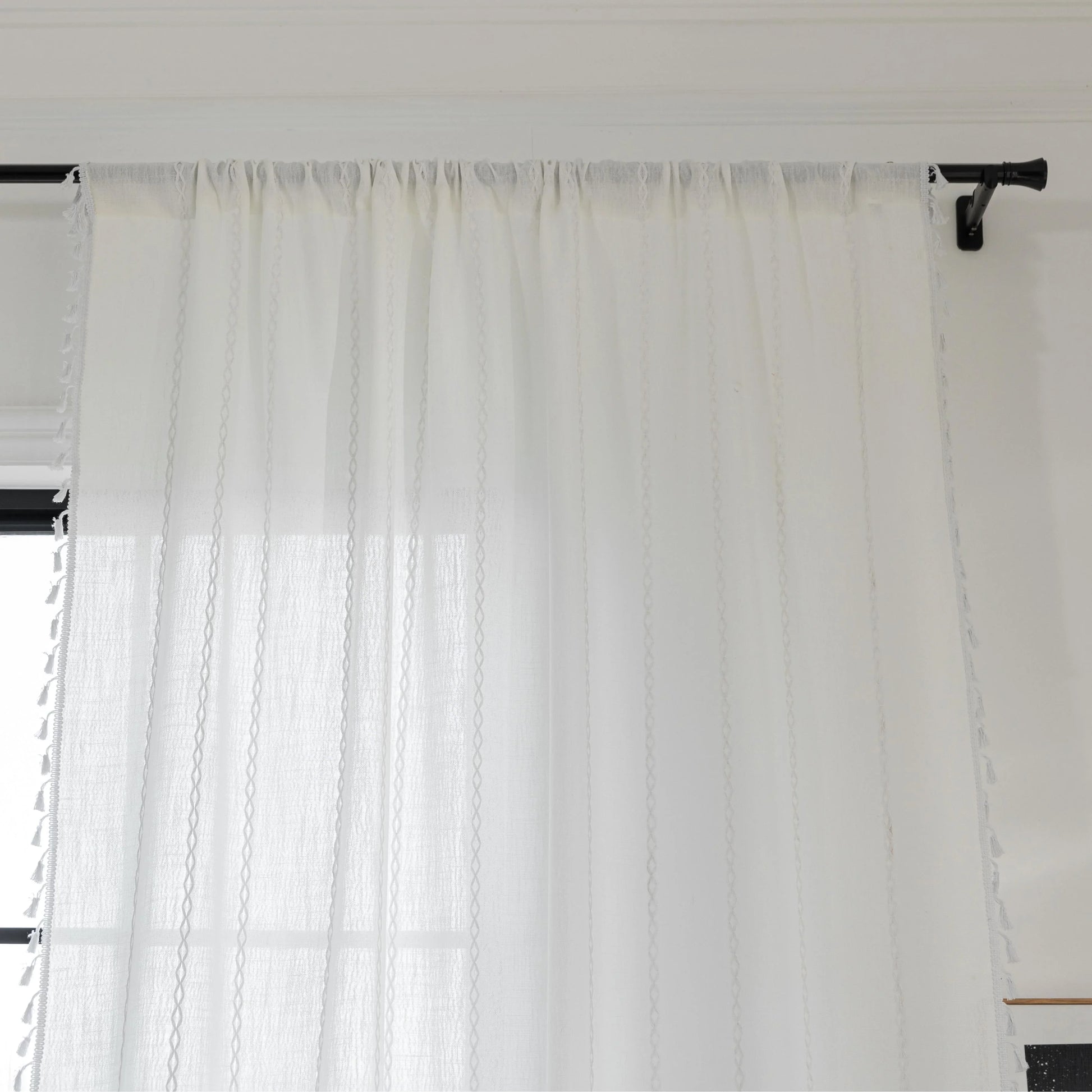 Elegant White Tassel Curtains – Bring timeless charm and brightness to your home with these beautiful white curtains, featuring subtle vertical embroidery and delicate tassel trim. Crafted from soft, airy fabric, they allow natural light to flow in while preserving your privacy. Perfect for living rooms, bedrooms, or dining spaces, their clean, versatile design complements modern, minimalist, coastal, or bohemian décor styles. Durable, easy to maintain, and effortlessly stylish, these curtains add a fresh a