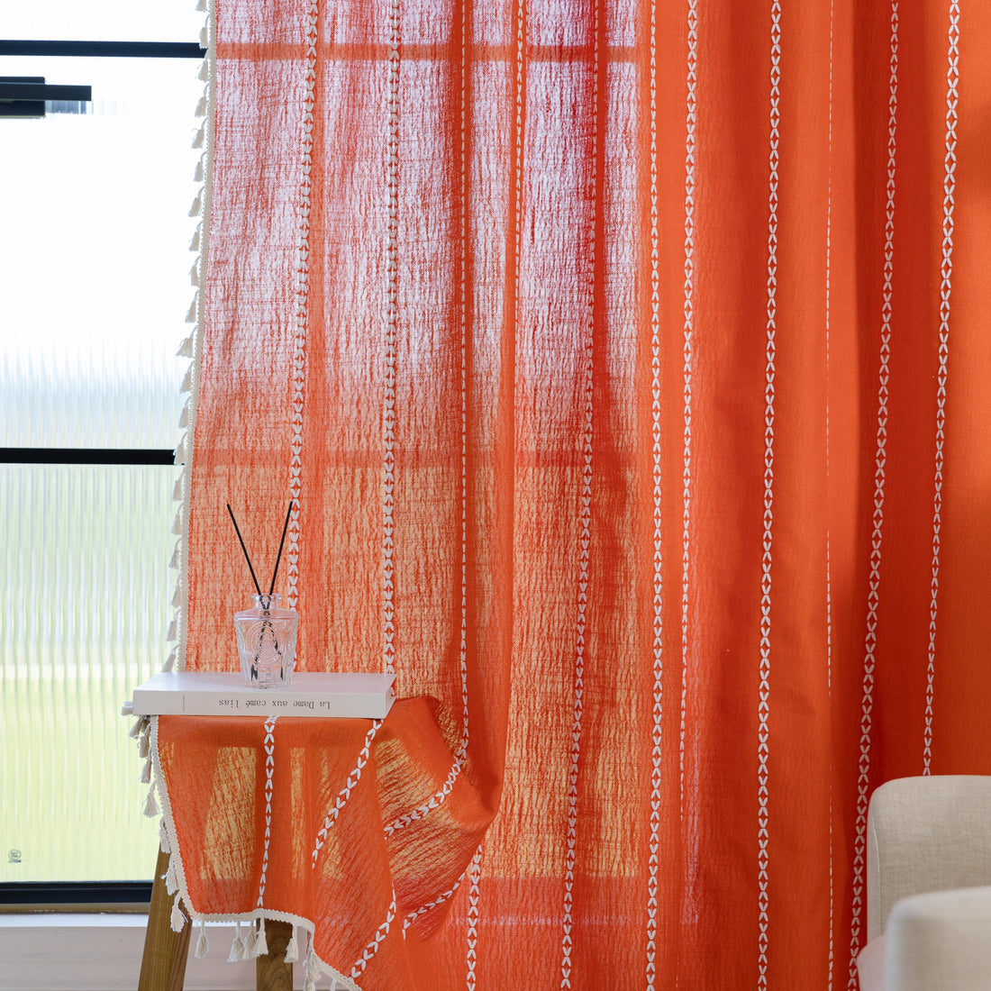 Vibrant Orange Tassel Curtains – Brighten up your space with these stunning orange curtains featuring elegant vertical white embroidery and charming tassel trim. Made from soft, breathable fabric, they allow gentle natural light to filter through while maintaining privacy. Perfect for adding a cheerful, modern touch to living rooms, bedrooms, or creative spaces, their bold color and artisanal detailing blend seamlessly with bohemian, eclectic, or contemporary décor. Durable, easy to care for, and stylish, t
