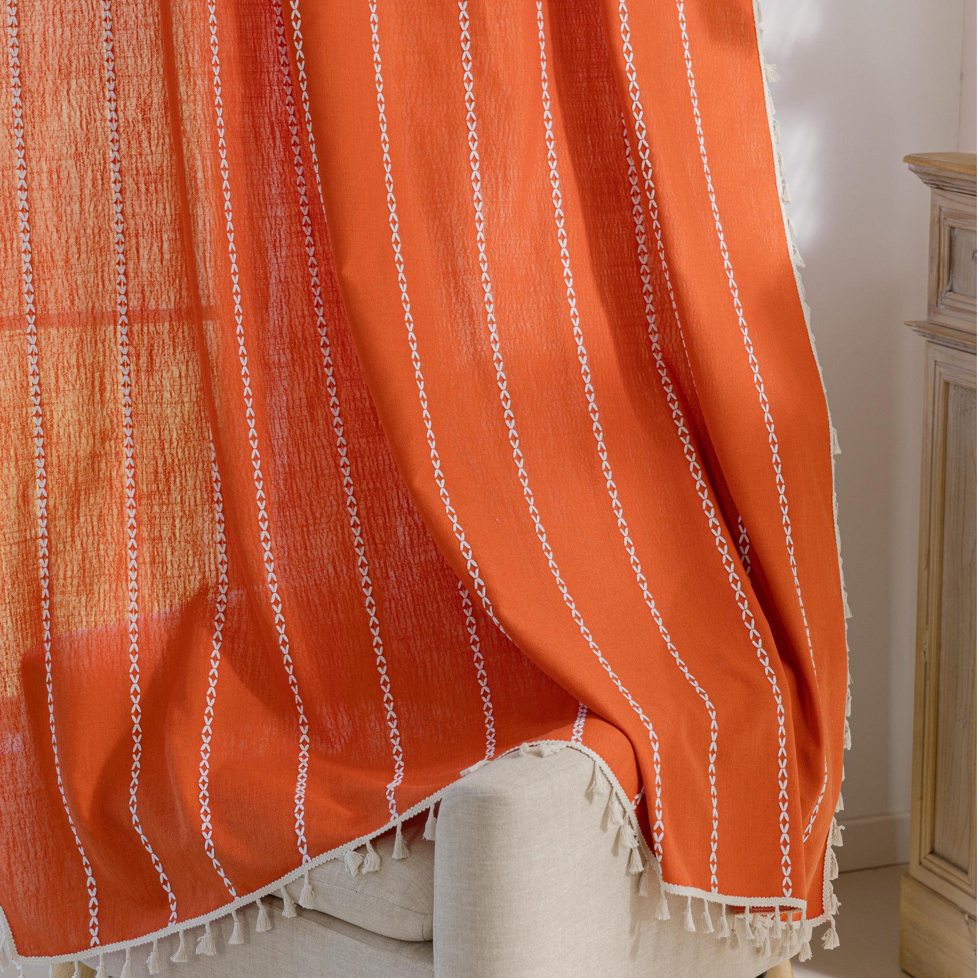 Vibrant Orange Tassel Curtains – Brighten up your space with these stunning orange curtains featuring elegant vertical white embroidery and charming tassel trim. Made from soft, breathable fabric, they allow gentle natural light to filter through while maintaining privacy. Perfect for adding a cheerful, modern touch to living rooms, bedrooms, or creative spaces, their bold color and artisanal detailing blend seamlessly with bohemian, eclectic, or contemporary décor. Durable, easy to care for, and stylish, t