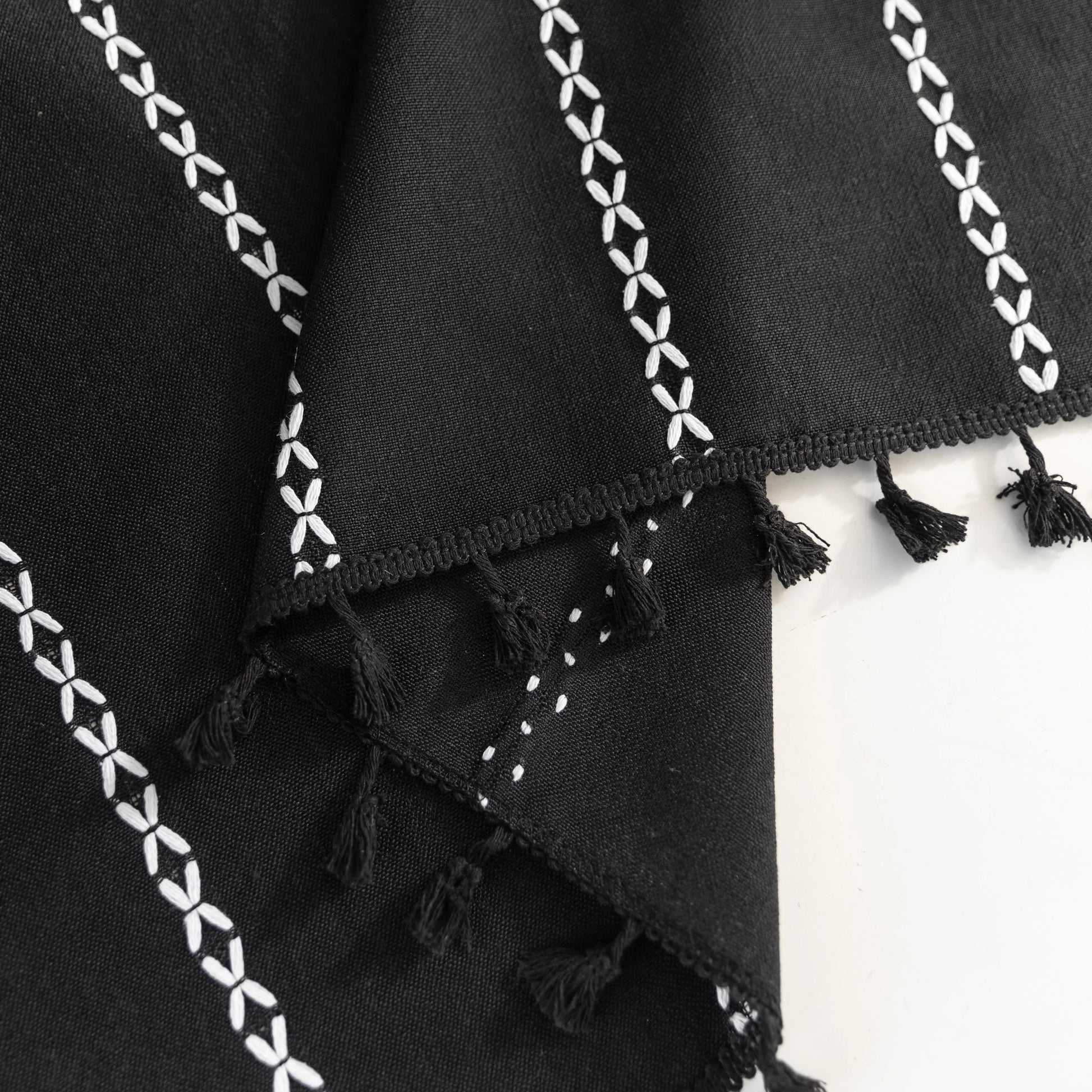 Elegant Black Tassel Curtains – Add a touch of sophistication to your home with these stylish black curtains featuring delicate vertical white embroidery and playful tassel trim. Crafted from lightweight, breathable fabric, they provide a perfect balance of privacy and natural light, making them ideal for living rooms, bedrooms, or reading nooks. The timeless black-and-white design complements modern, bohemian, and contemporary interiors, while the tassel detailing adds a chic, artisanal flair. Durable and 