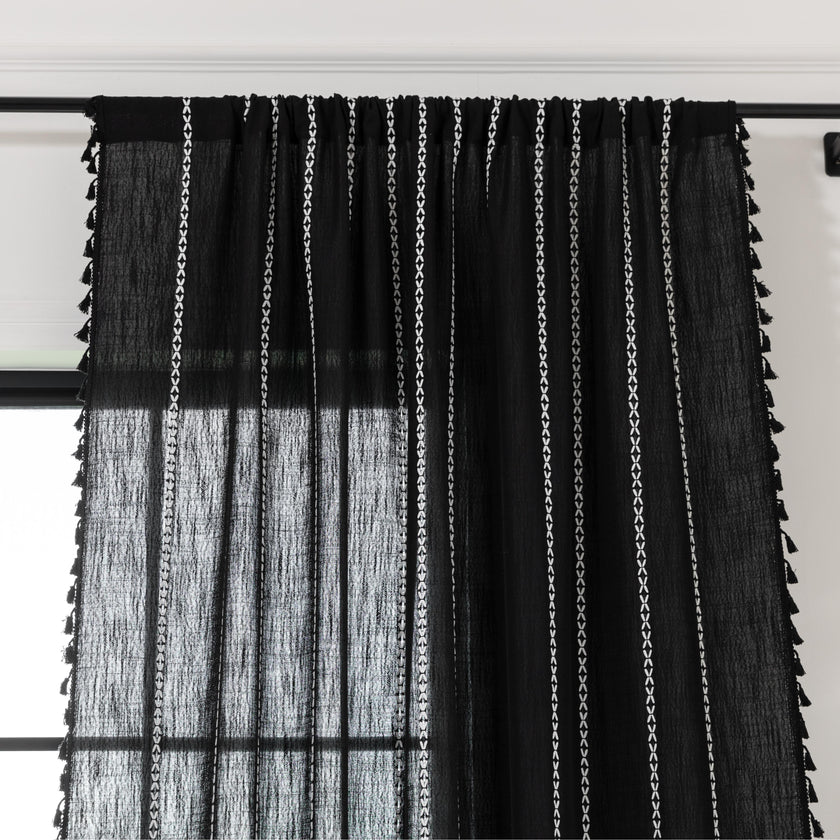 Elegant Black Tassel Curtains ¨C Add a touch of sophistication to your home with these stylish black curtains featuring delicate vertical white embroidery and playful tassel trim. Crafted from lightweight, breathable fabric, they provide a perfect balance of privacy and natural light, making them ideal for living rooms, bedrooms, or reading nooks. The timeless black-and-white design complements modern, bohemian, and contemporary interiors, while the tassel detailing adds a chic, artisanal flair. Durable and