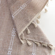 Khaki and white embroidered curtain in a living space