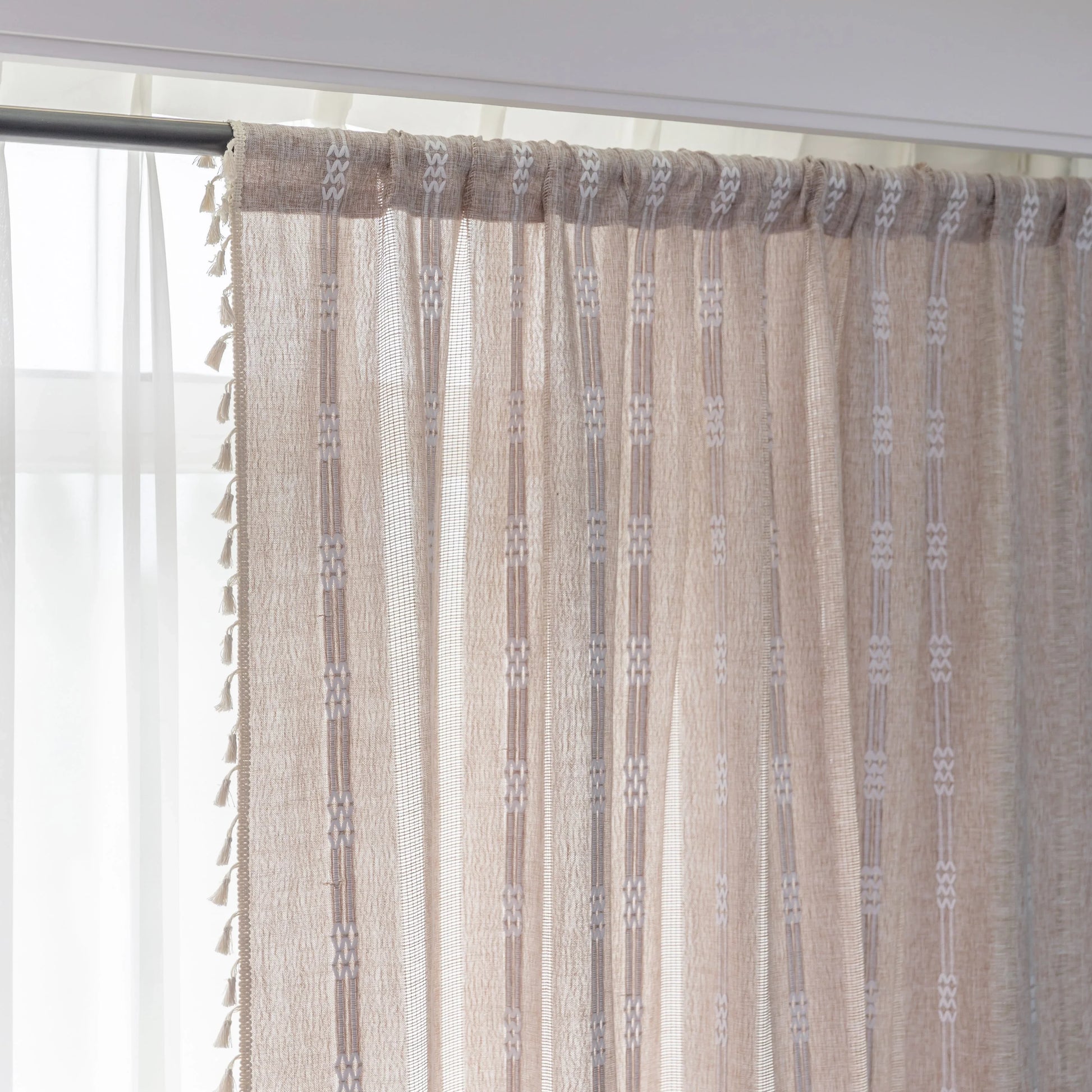 Light beige sheer curtain with subtle white embroidery and tassel edging — a breezy, elegant window treatment perfect for adding softness, texture, and natural light to any room décor.