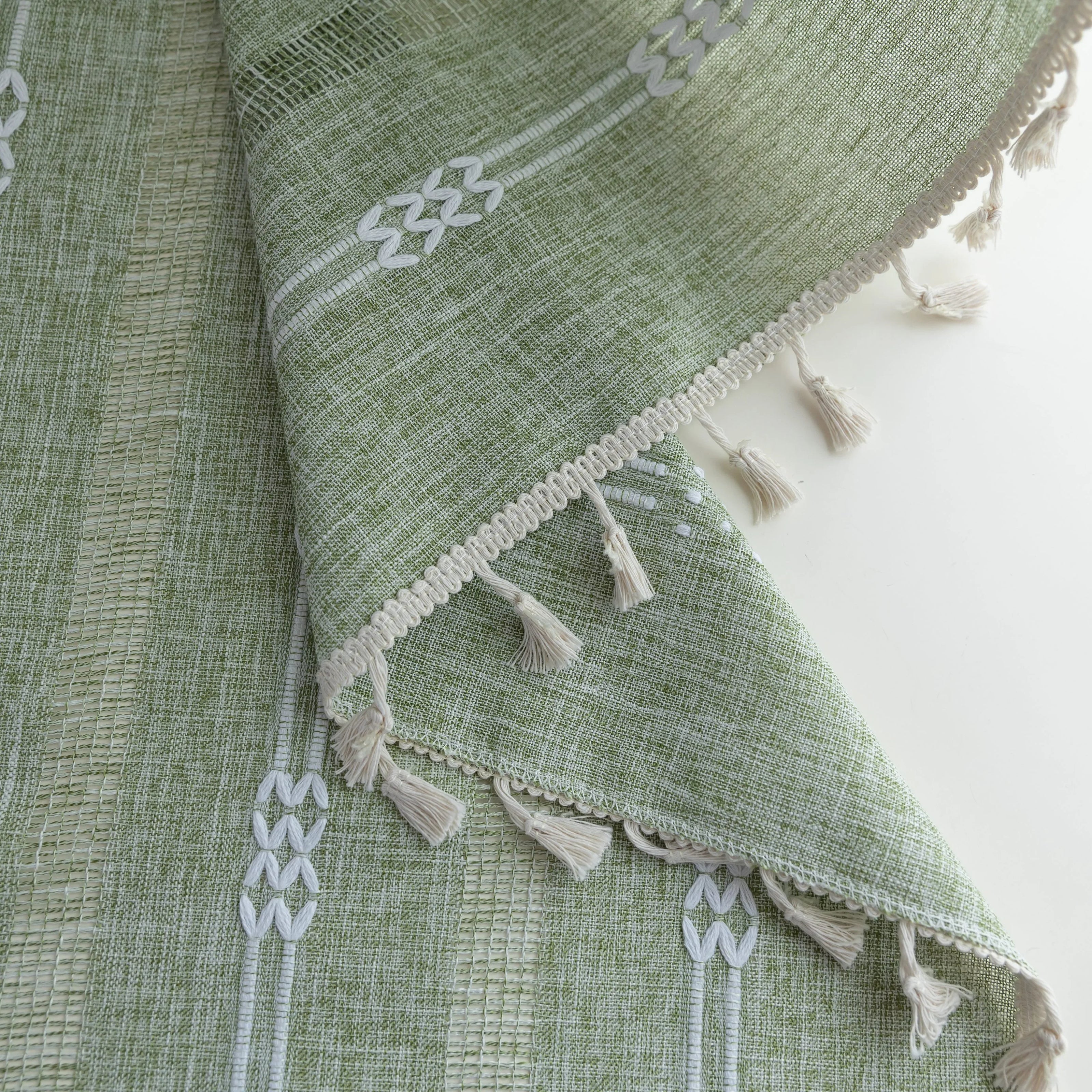 Soft green curtain with delicate vertical white embroidery and tassel trim ¡ª an airy and stylish window treatment ideal for creating a light, refreshing, and cozy atmosphere in any room.