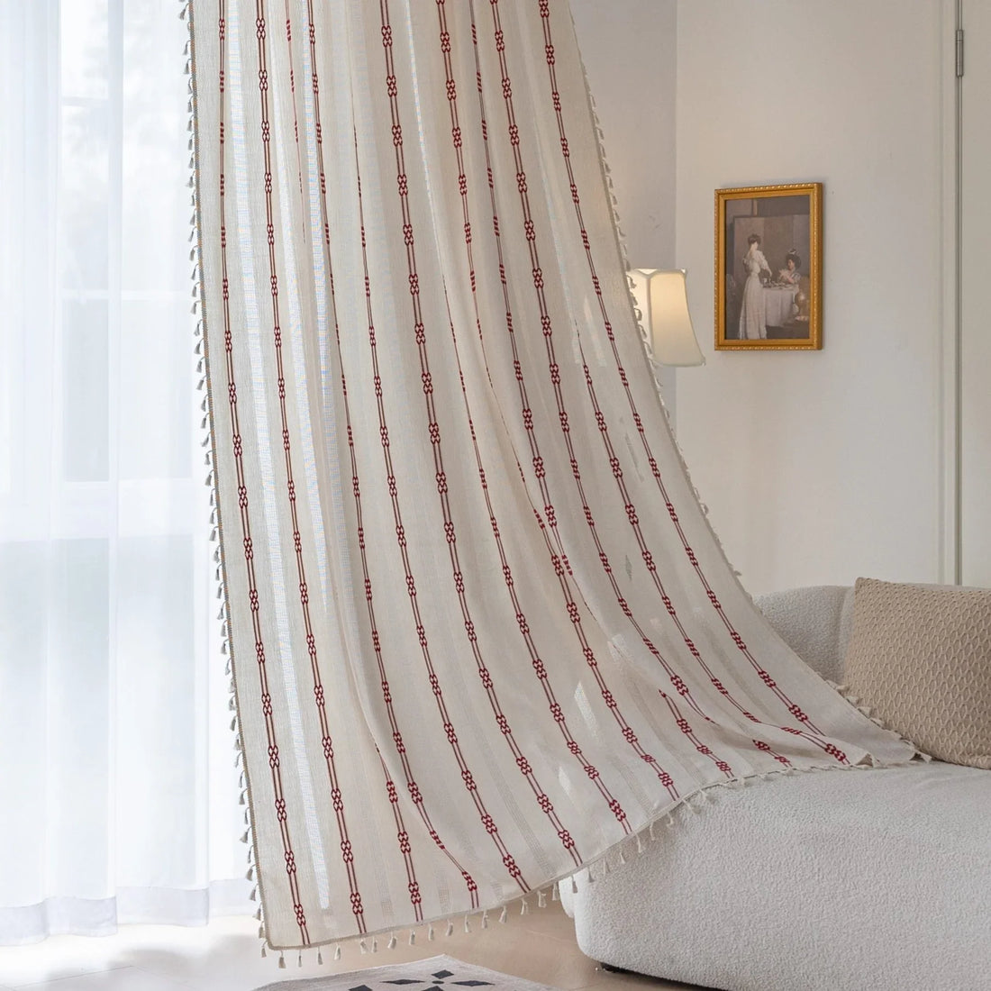 Elegant white curtain with vertical red embroidered stripes and subtle tassel edging — perfect for adding a touch of sophistication and warmth to your living room or bedroom décor.