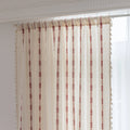 Elegant white curtain with vertical red embroidered stripes and subtle tassel edging — perfect for adding a touch of sophistication and warmth to your living room or bedroom décor.