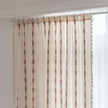 Red embroidery curtain hanging by a window