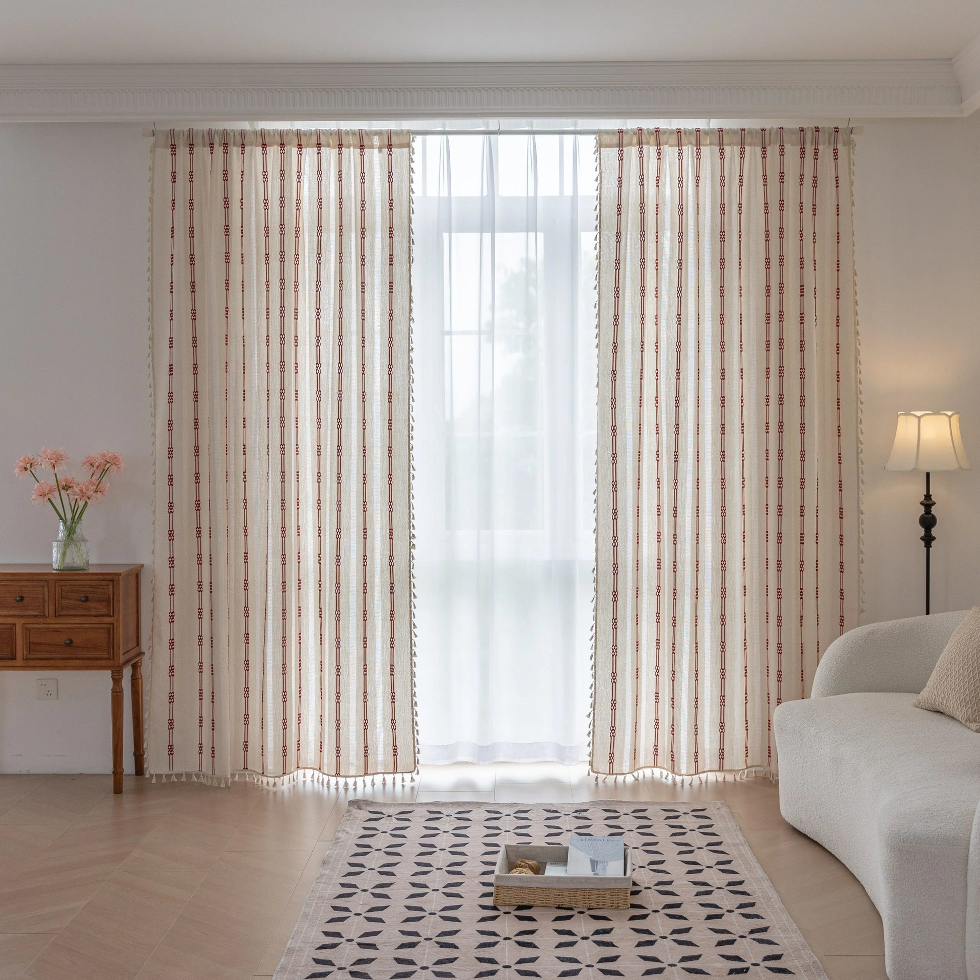 Elegant white curtain with vertical red embroidered stripes and subtle tassel edging — perfect for adding a touch of sophistication and warmth to your living room or bedroom décor.