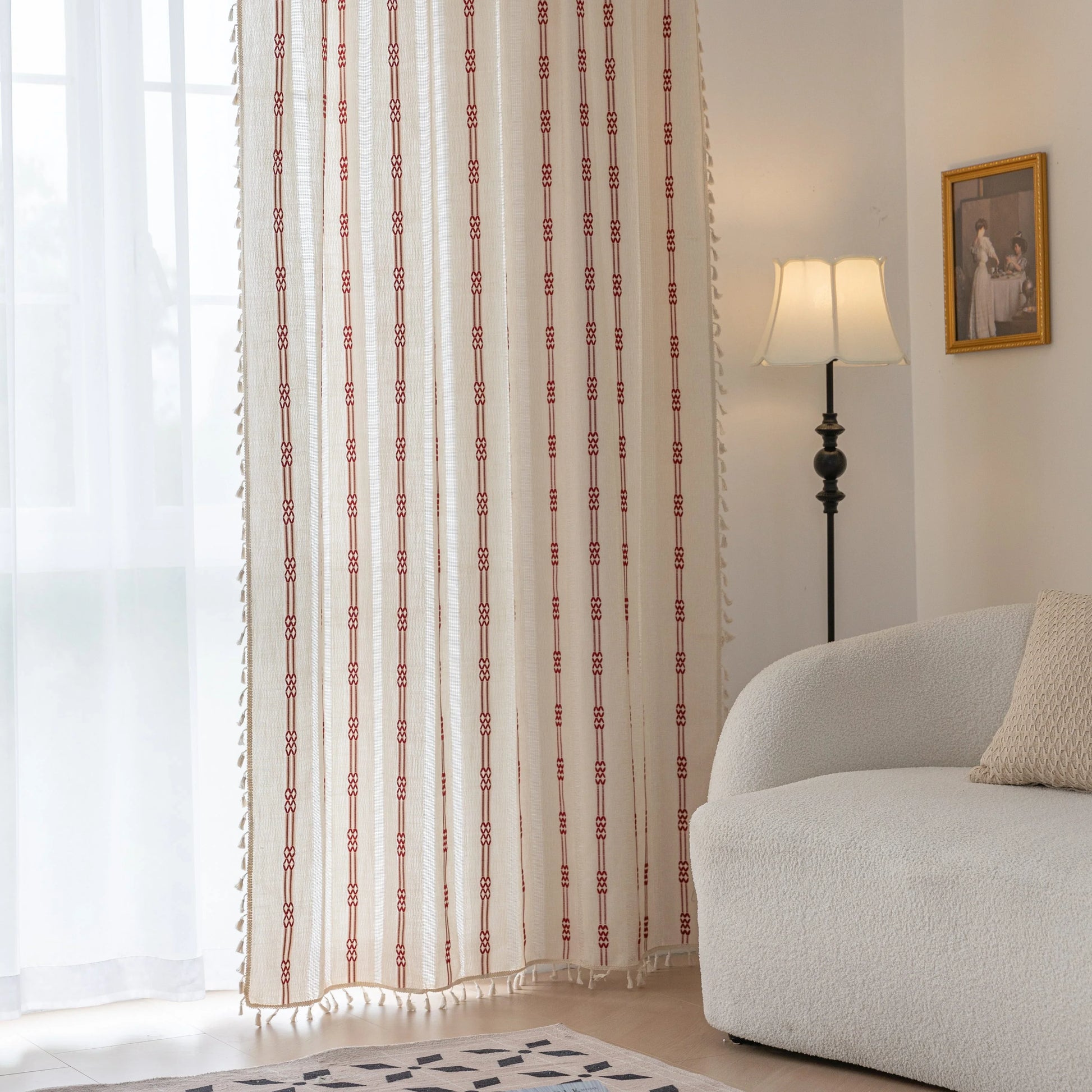 Elegant white curtain with vertical red embroidered stripes and subtle tassel edging — perfect for adding a touch of sophistication and warmth to your living room or bedroom décor.