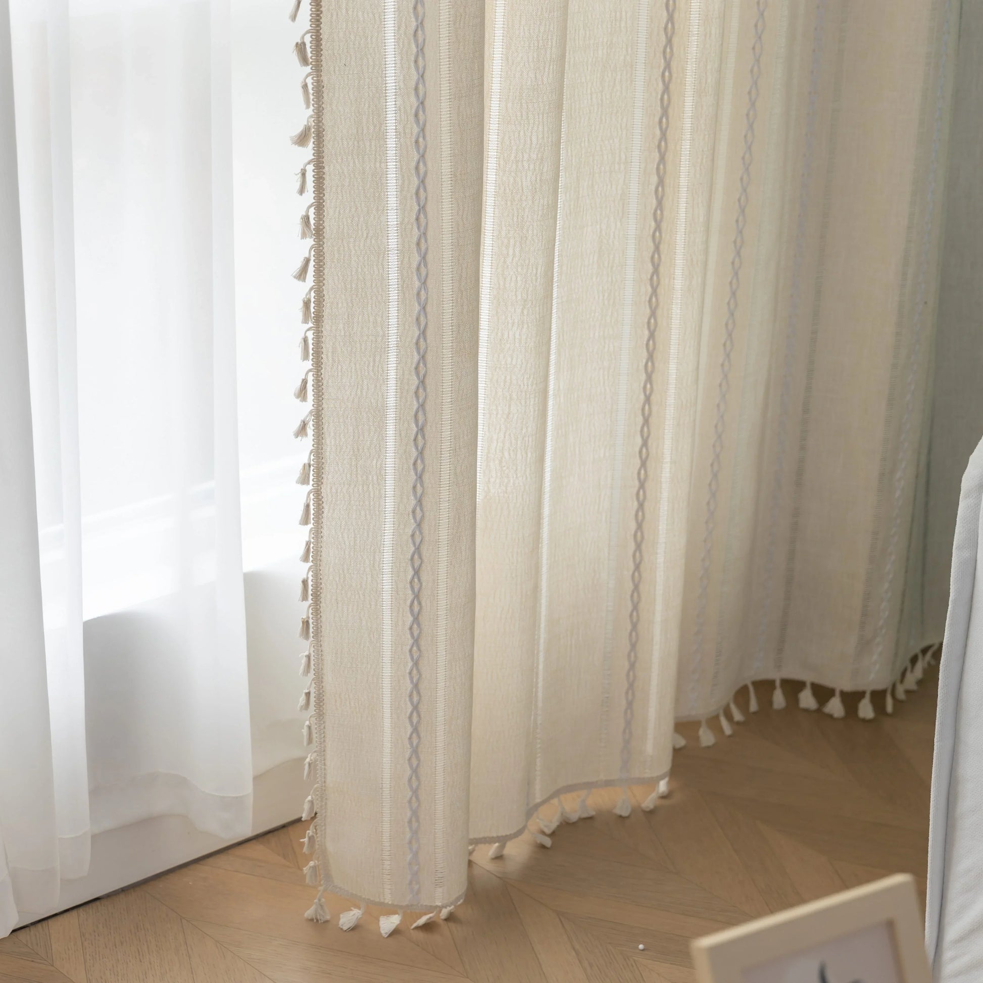 Beige Sheer Tassel Curtains – Elevate your space with these soft beige curtains featuring subtle pastel stripe accents for a touch of modern elegance. Crafted from lightweight, semi-sheer fabric, they gently diffuse sunlight while providing a cozy layer of privacy. The delicate tassel edging adds a charming boho-inspired finish, making them perfect for living rooms, bedrooms, or reading nooks. Ideal for creating a warm, inviting atmosphere in any home décor style.
