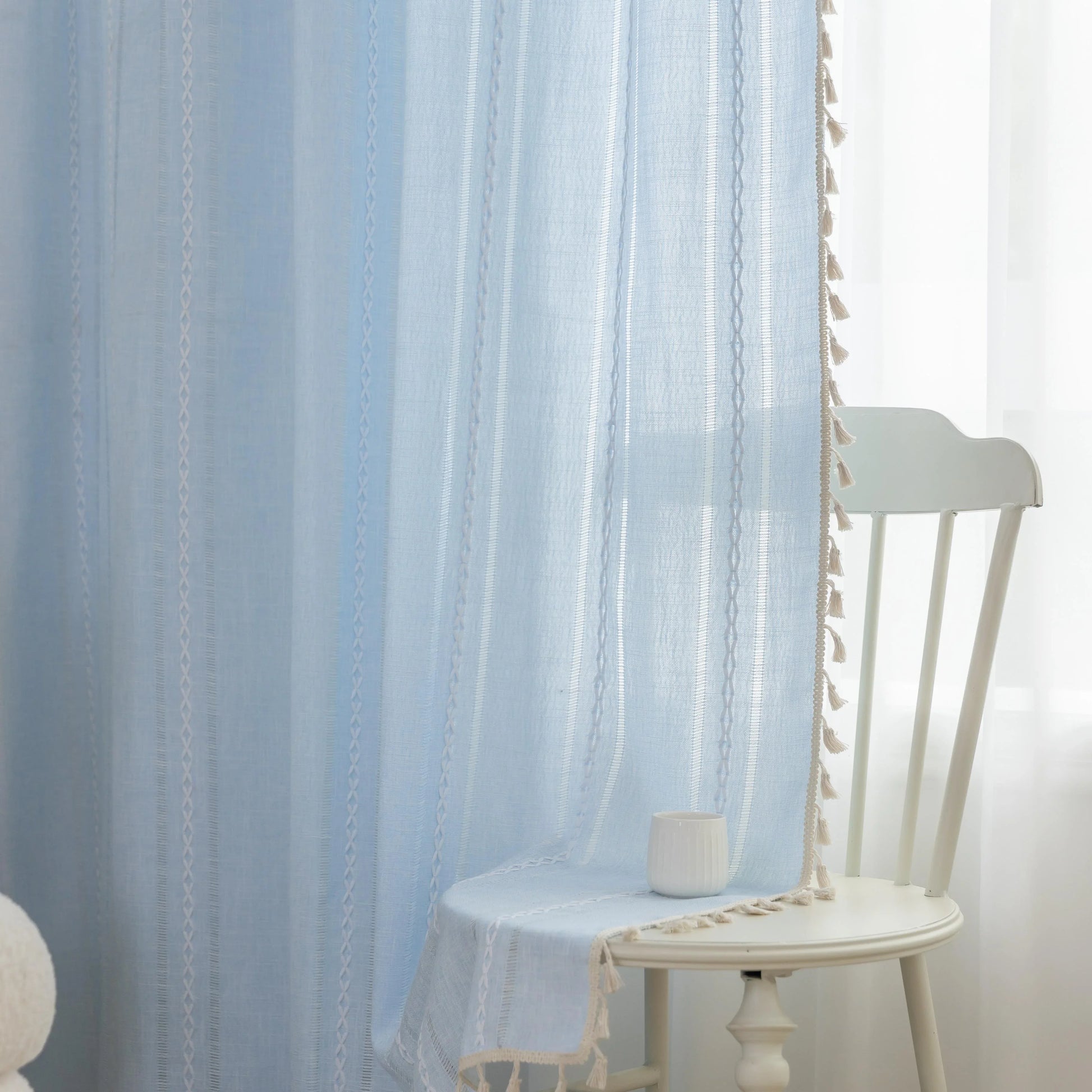 Light Blue Sheer Tassel Curtains – Bring a refreshing, airy charm to your home with these elegant light blue curtains, designed with delicate vertical weave patterns for subtle texture and style. The lightweight, semi-sheer fabric allows natural light to filter through while providing a soft layer of privacy. Finished with playful tassel edges, these curtains add a touch of coastal, bohemian, or contemporary elegance to any living room, bedroom, or dining area. Perfect for creating a serene and inviting atm