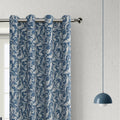 Elegant blue blackout curtain with intricate white floral patterns, designed to block sunlight, enhance privacy, and add a sophisticated touch to any living room or bedroom décor.