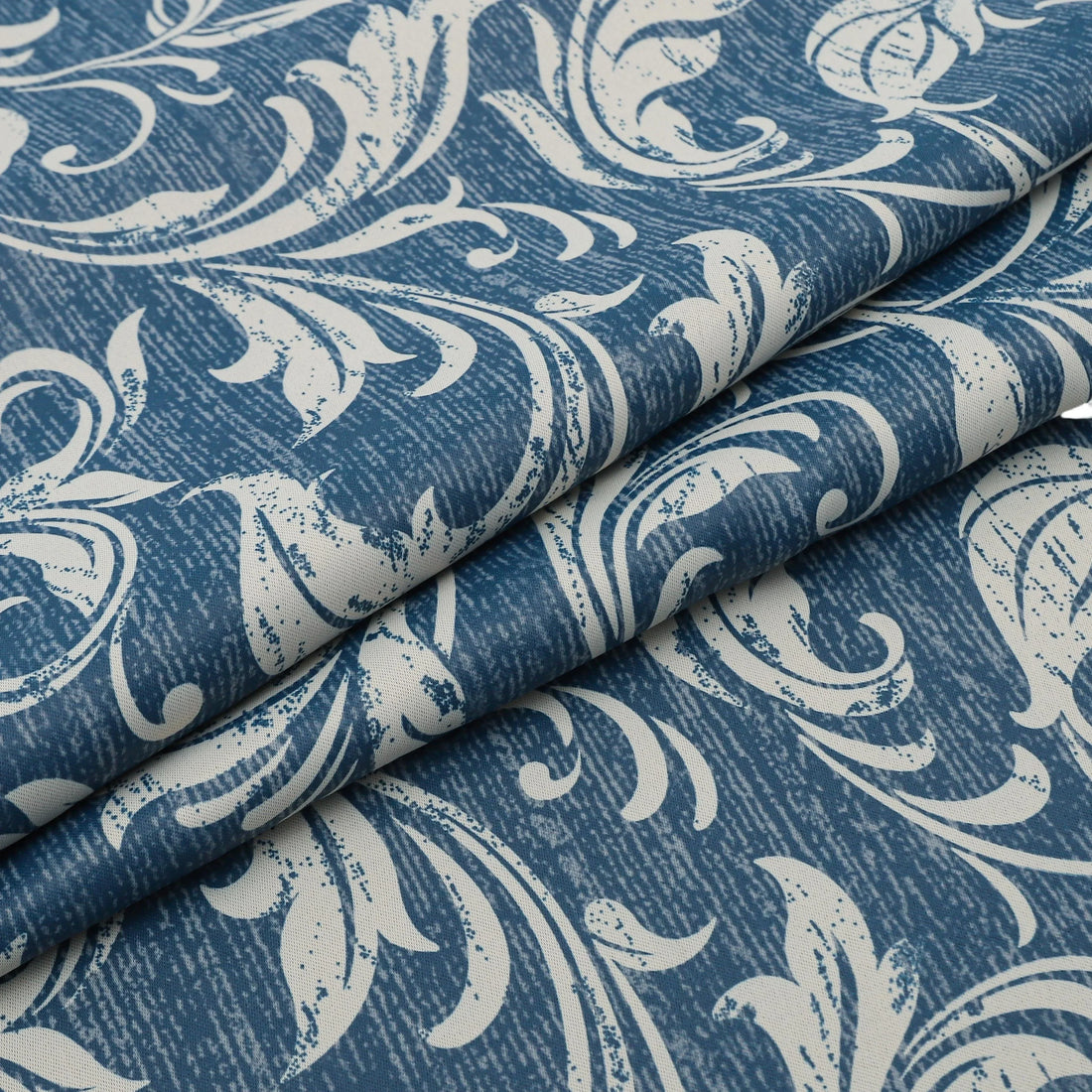 Elegant blue blackout curtain with intricate white floral patterns, designed to block sunlight, enhance privacy, and add a sophisticated touch to any living room or bedroom décor.