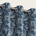 Elegant blue blackout curtain with intricate white floral patterns, designed to block sunlight, enhance privacy, and add a sophisticated touch to any living room or bedroom décor.