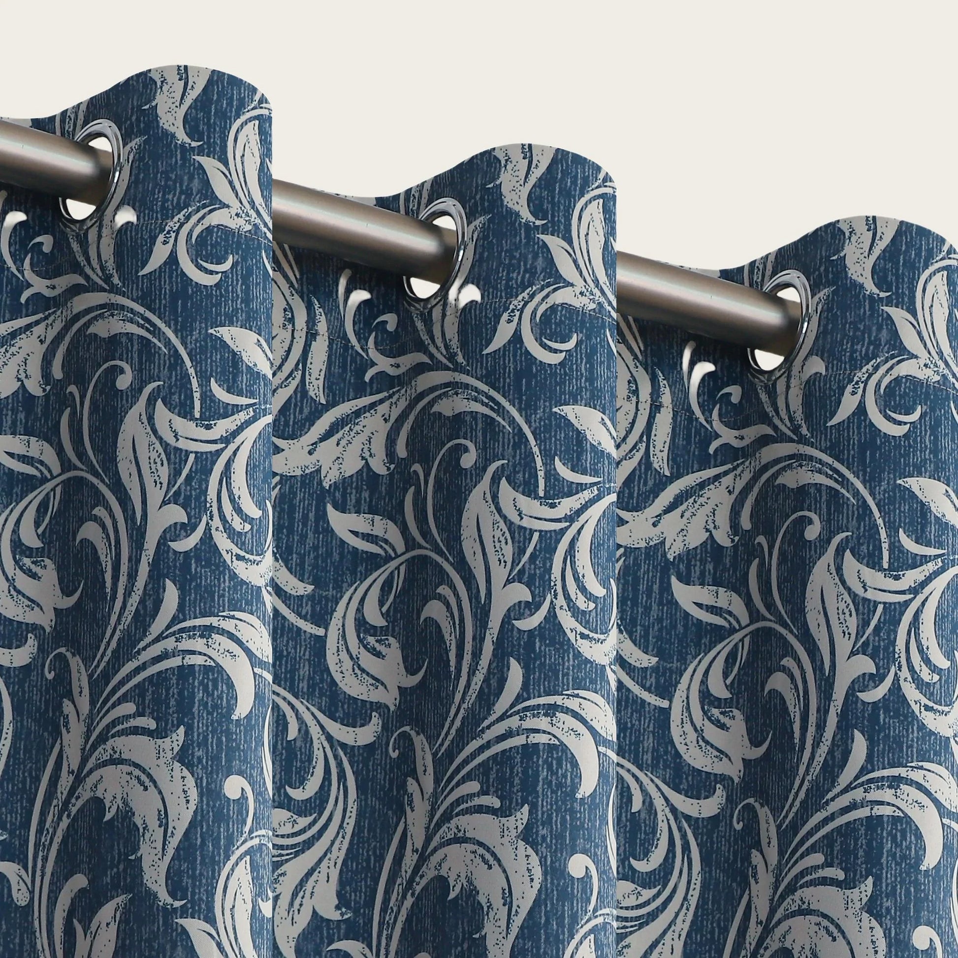 Elegant blue blackout curtain with intricate white floral patterns, designed to block sunlight, enhance privacy, and add a sophisticated touch to any living room or bedroom décor.