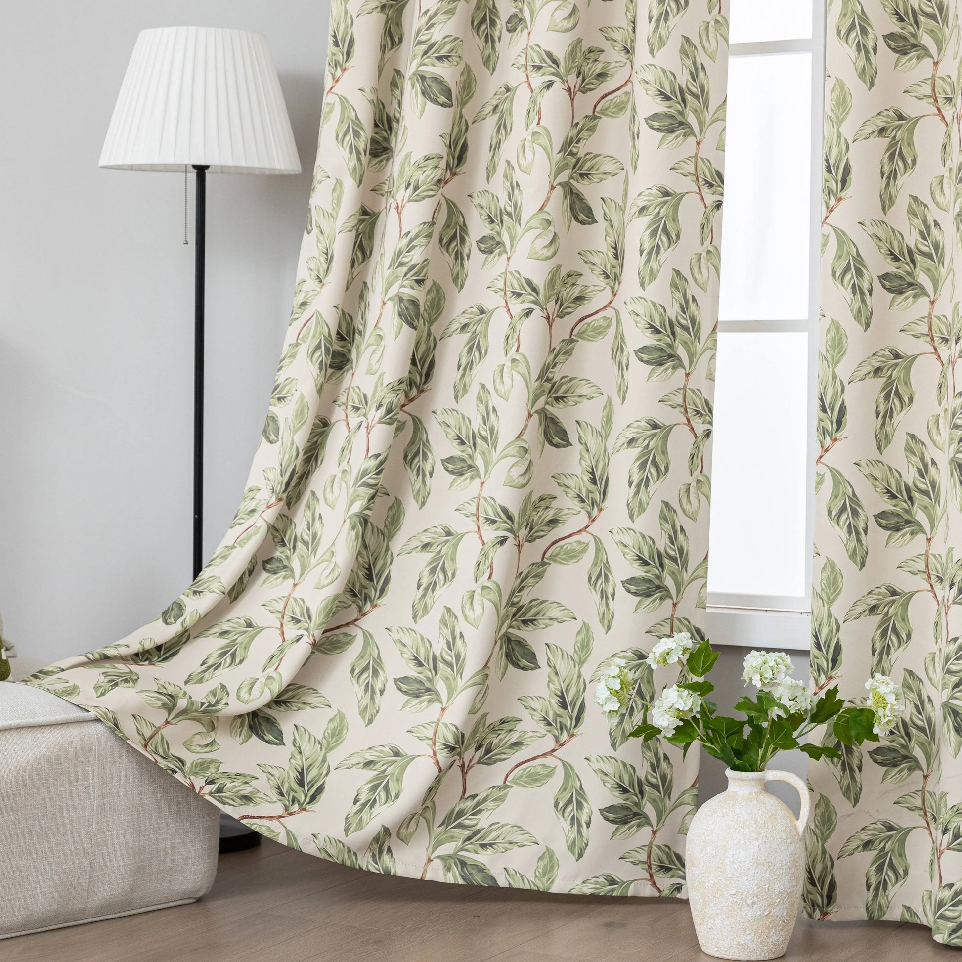 Nature-inspired blackout curtain with lush green leaf prints on a beige background, designed to block sunlight, enhance privacy, and bring a fresh, botanical charm to your living room, bedroom, or dining space.